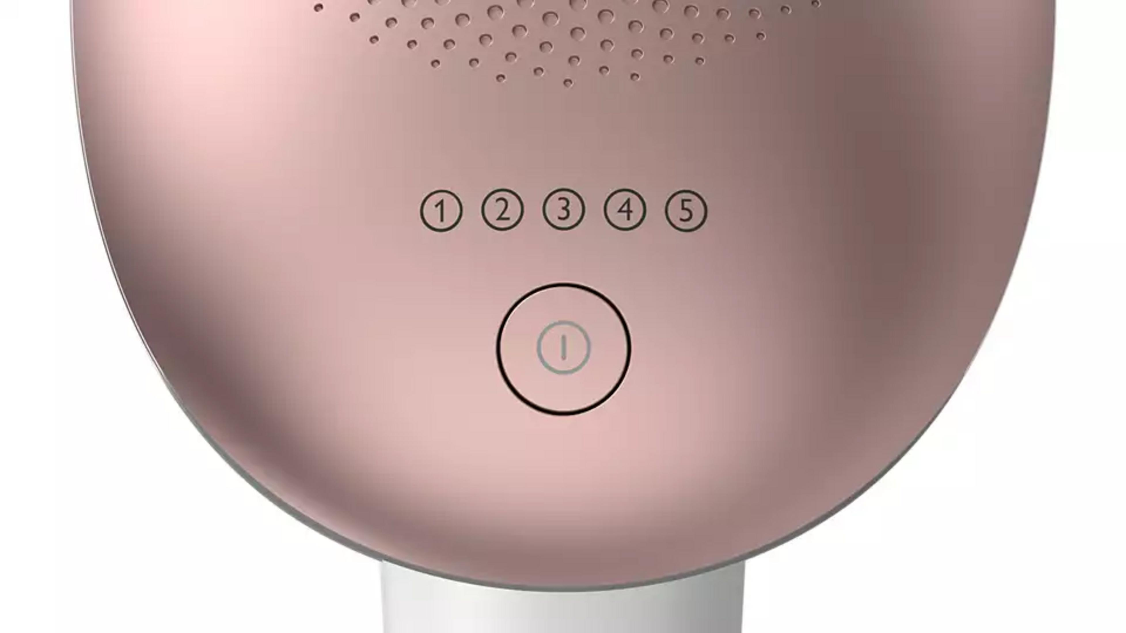 Primer plano de un dispositivo rosa dorado con botones numerados (1-5) y un botón de encendido.