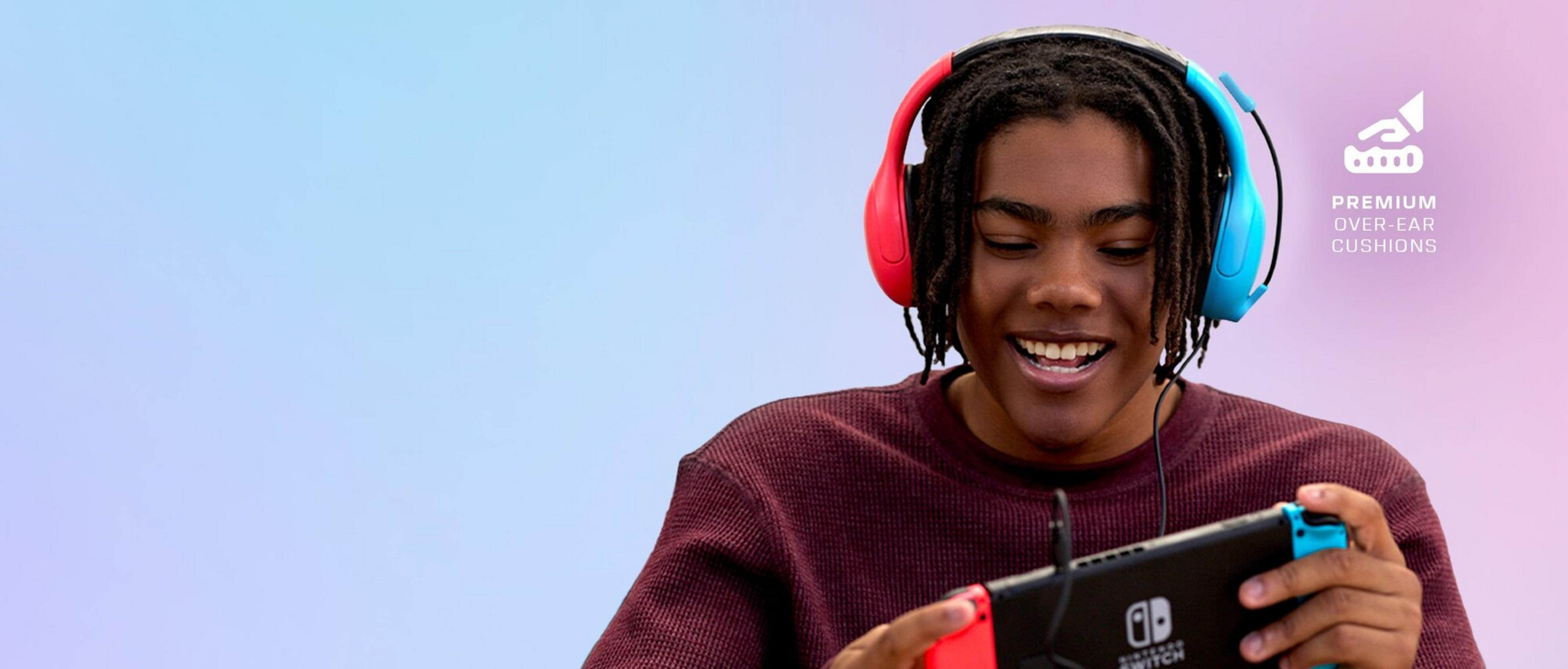 Jonge man met koptelefoon speelt Nintendo Switch, paars-blauwe achtergrond.