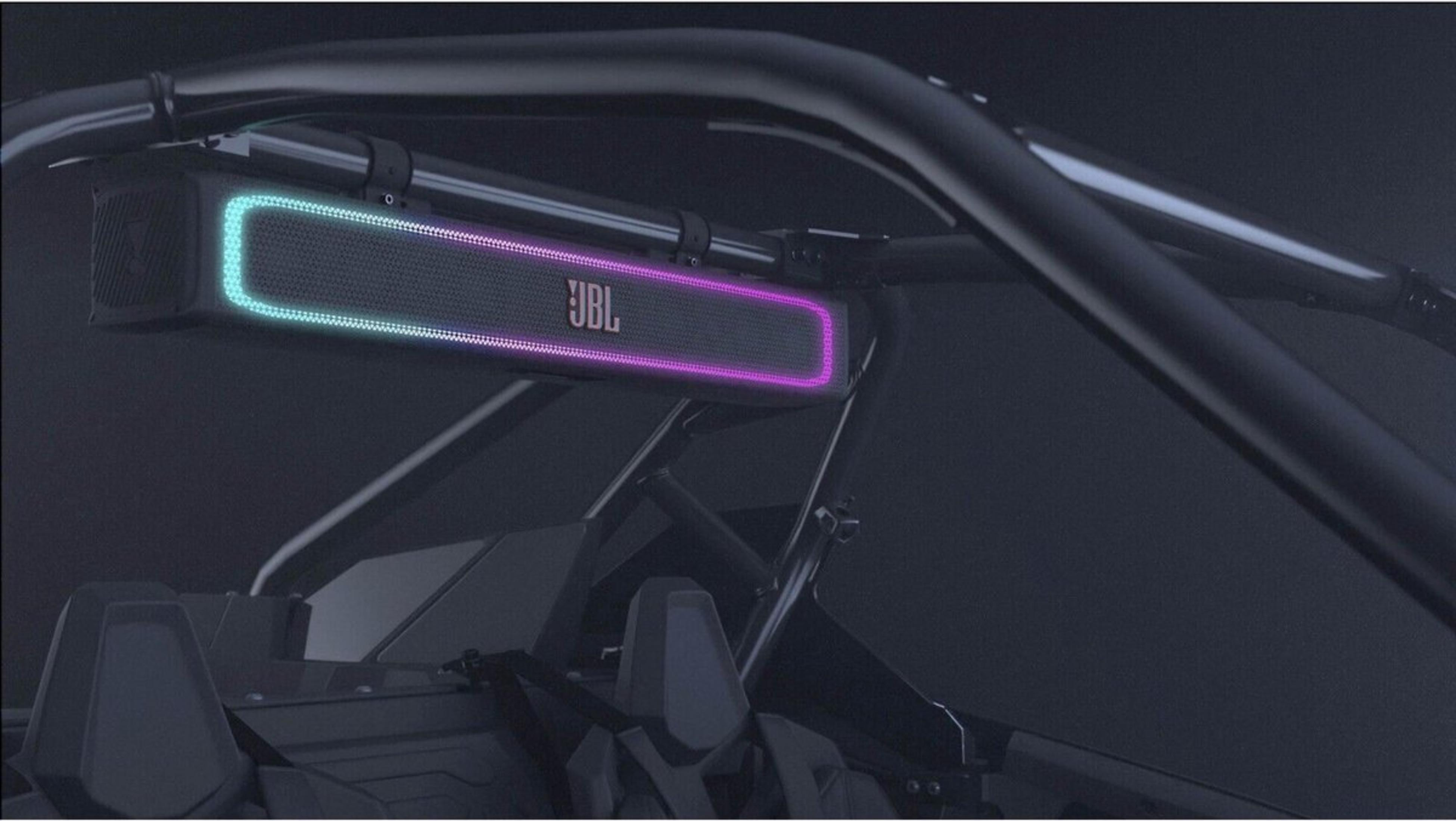 A JBL speaker with blue and purple lights is mounted above the seats.