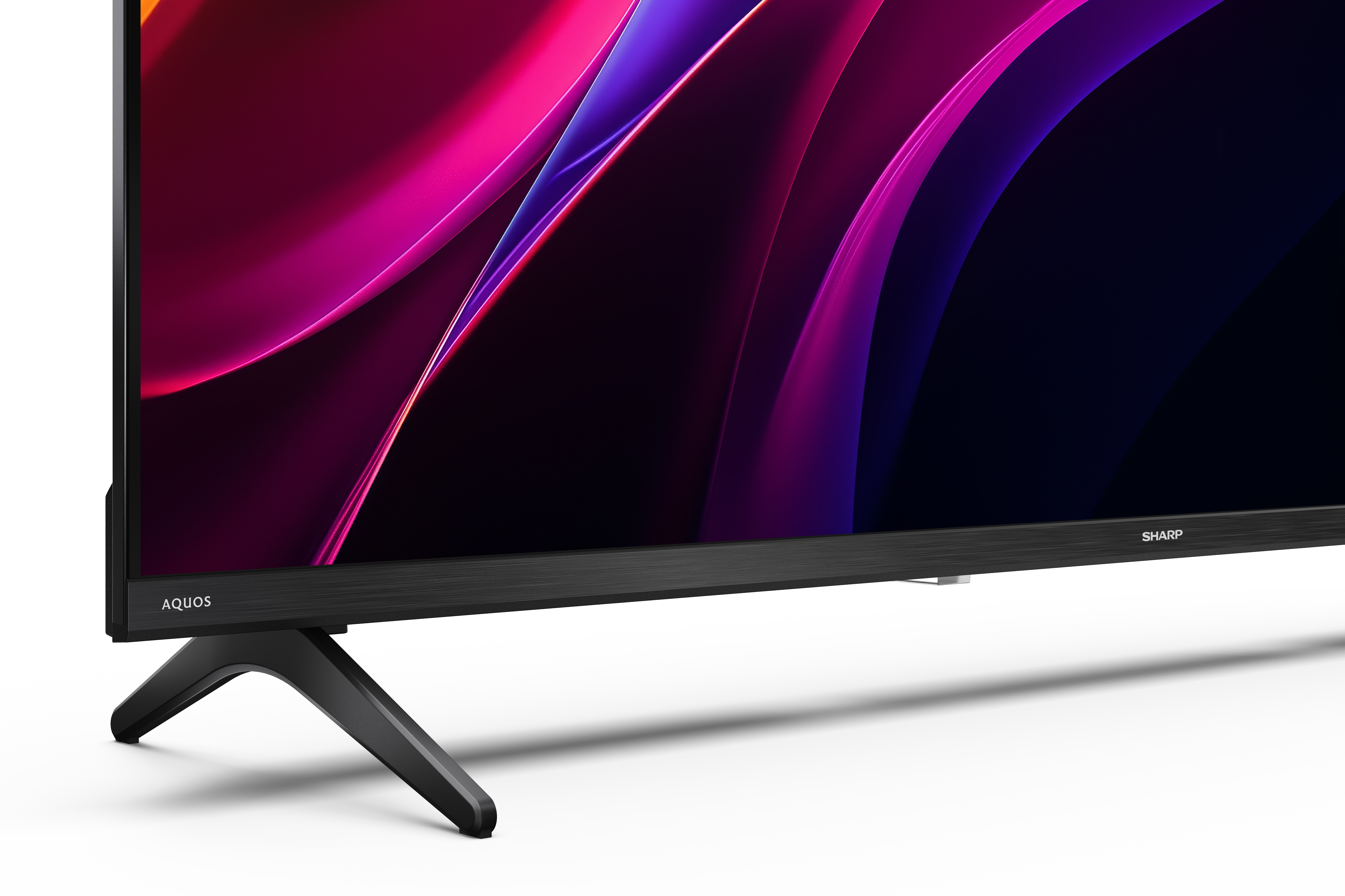 Ein Fernseher mit einem abstrakten, bunten Hintergrund und dem Schriftzug AQUOS und SHARP.