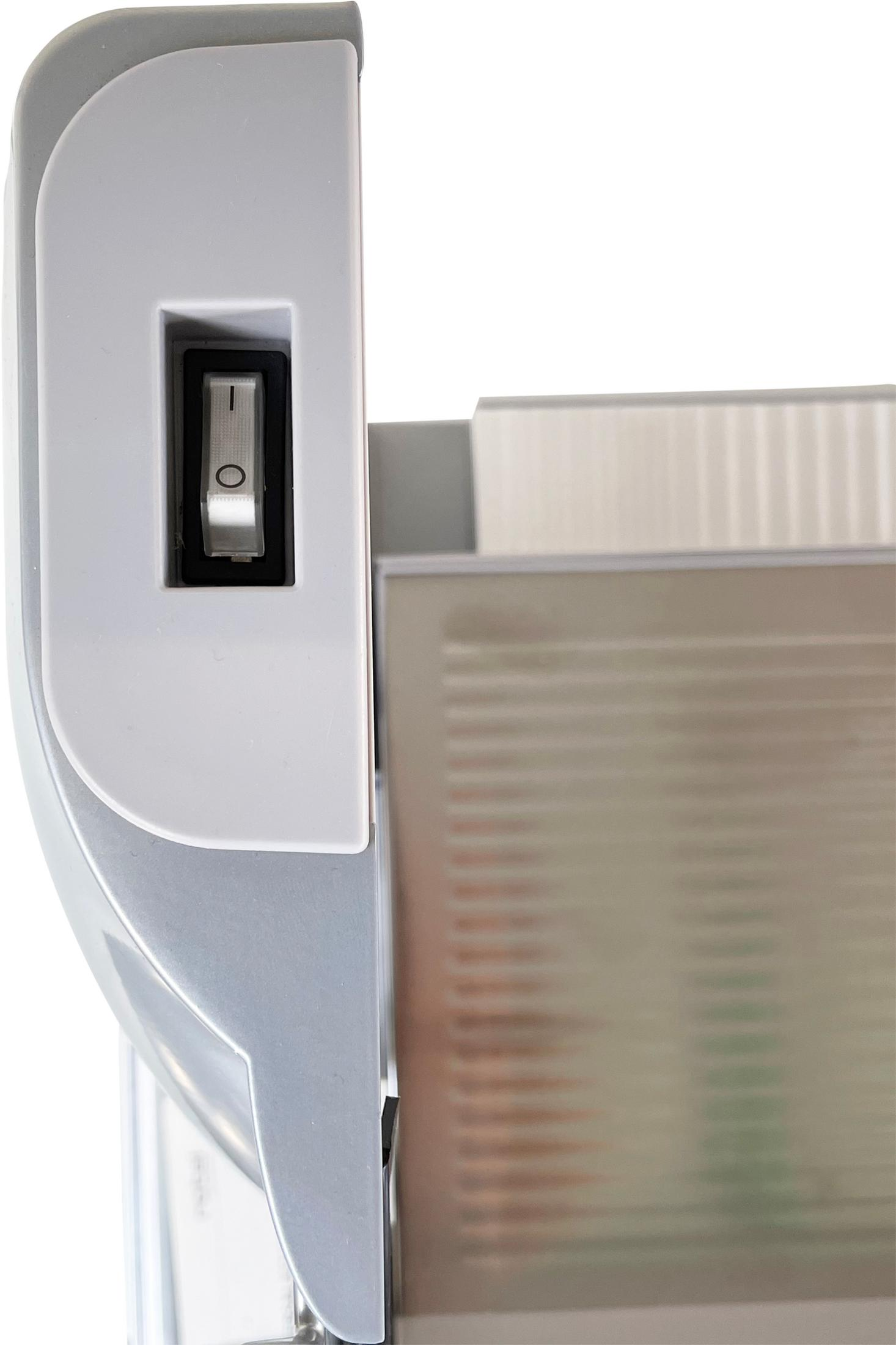 Un interruttore a levetta su un dispositivo bianco e grigio.
