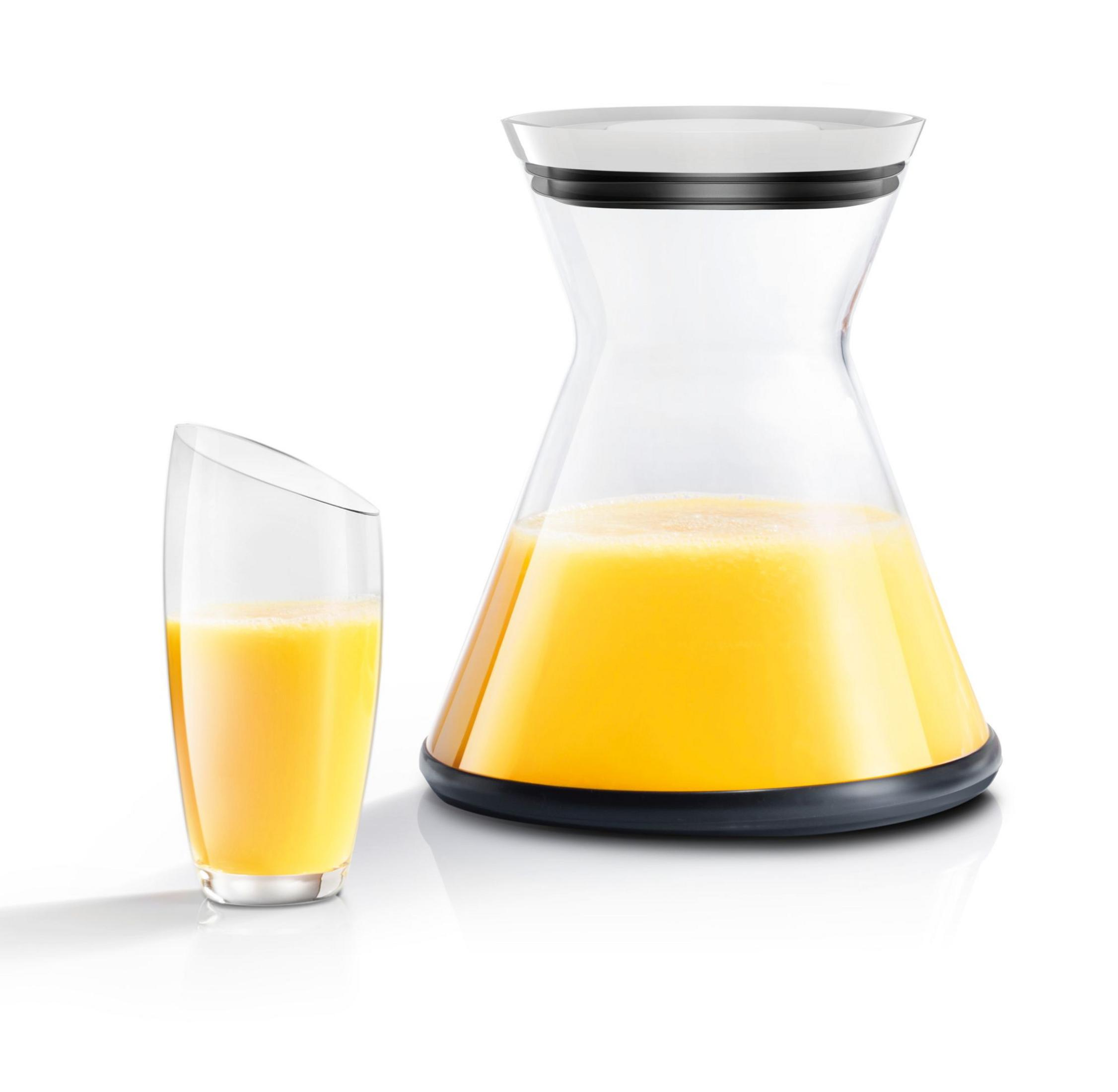 Un vaso y una jarra con jugo de naranja sobre fondo blanco.