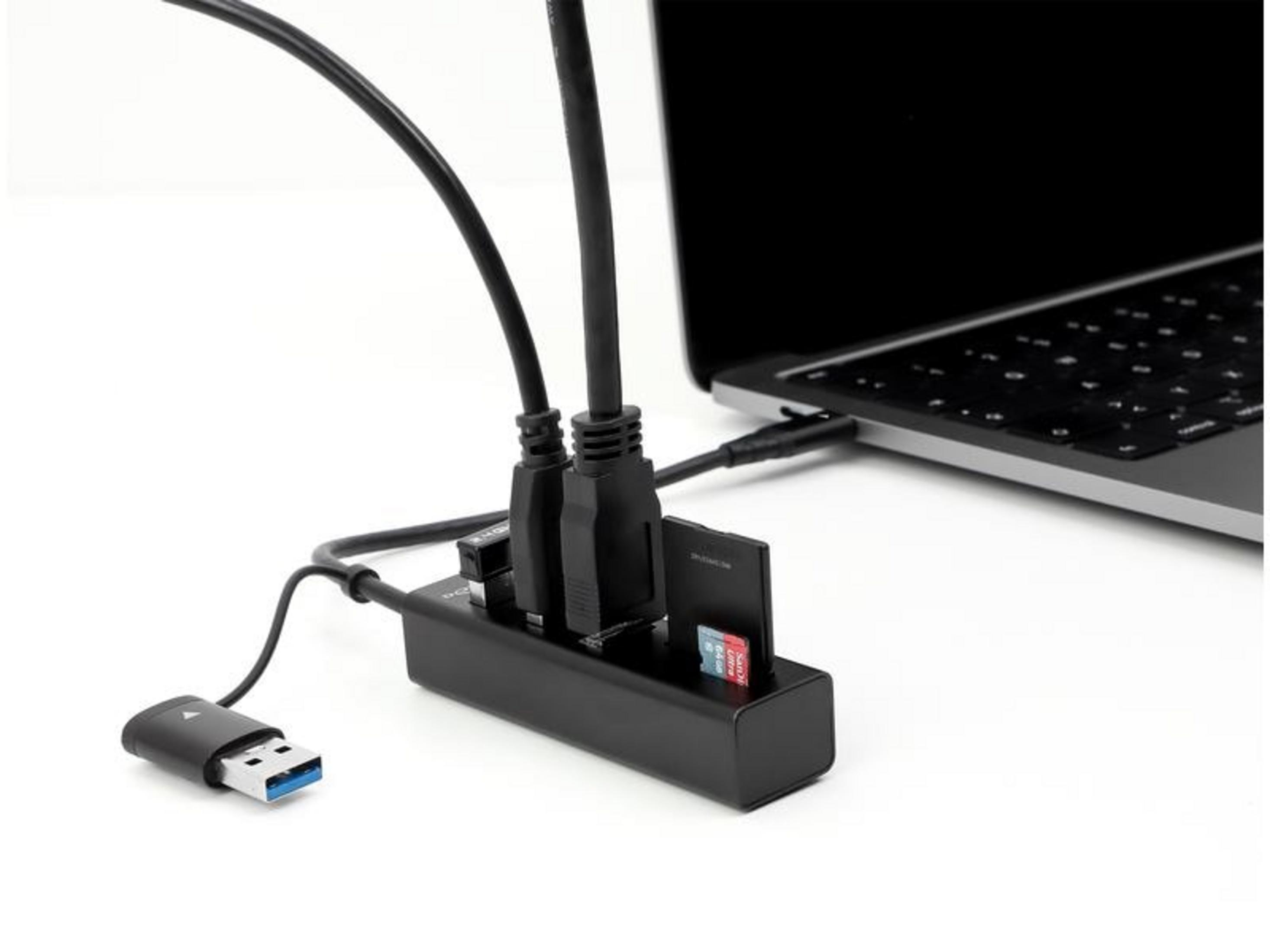 Schwarzer USB-Hub mit Kartenleser, verbunden mit einem Laptop. USB-Geräte sind eingesteckt.