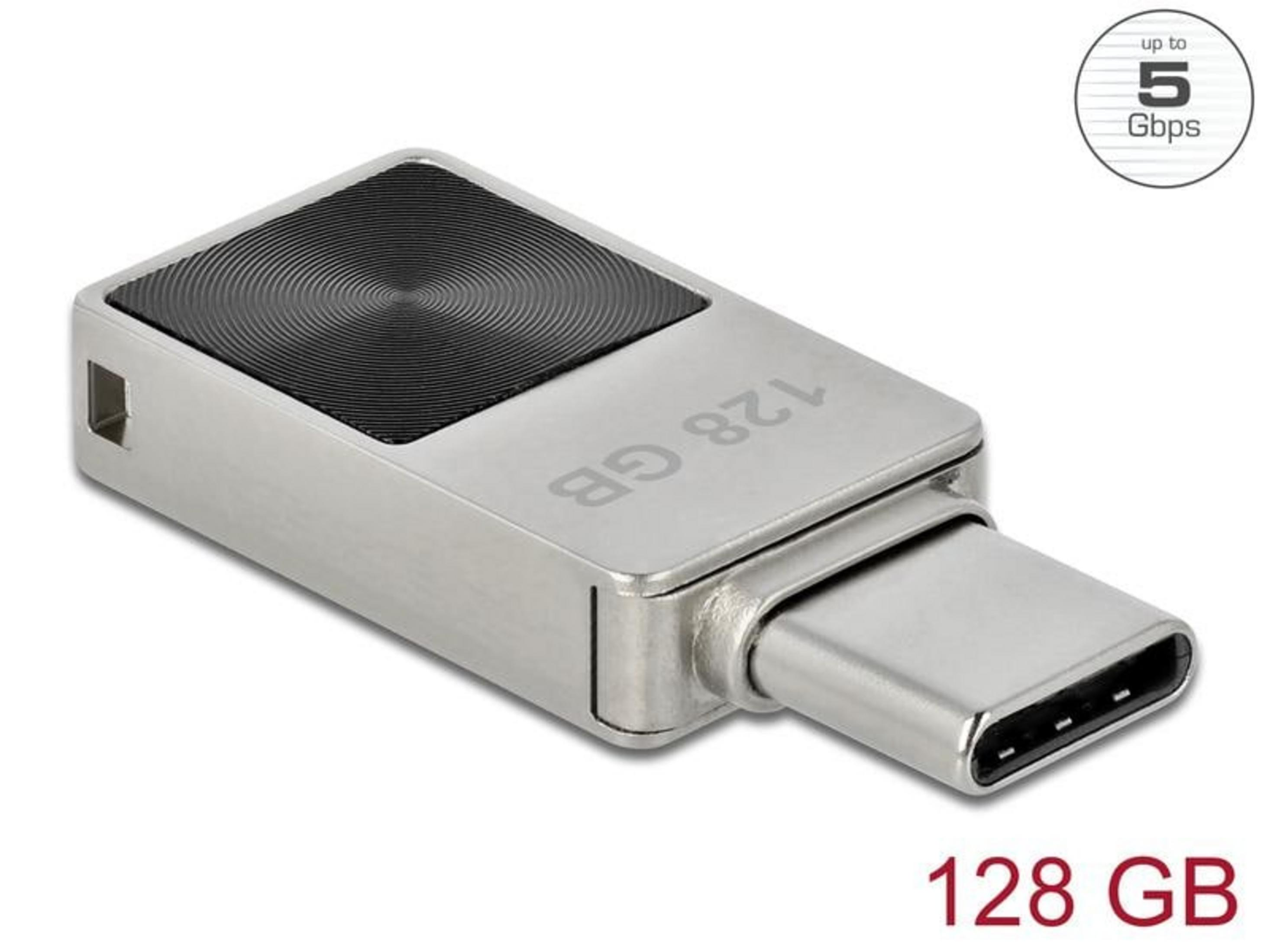 Srebrny pendrive USB-C 128 GB z czarnym, koncentrycznym wzorem na górze.