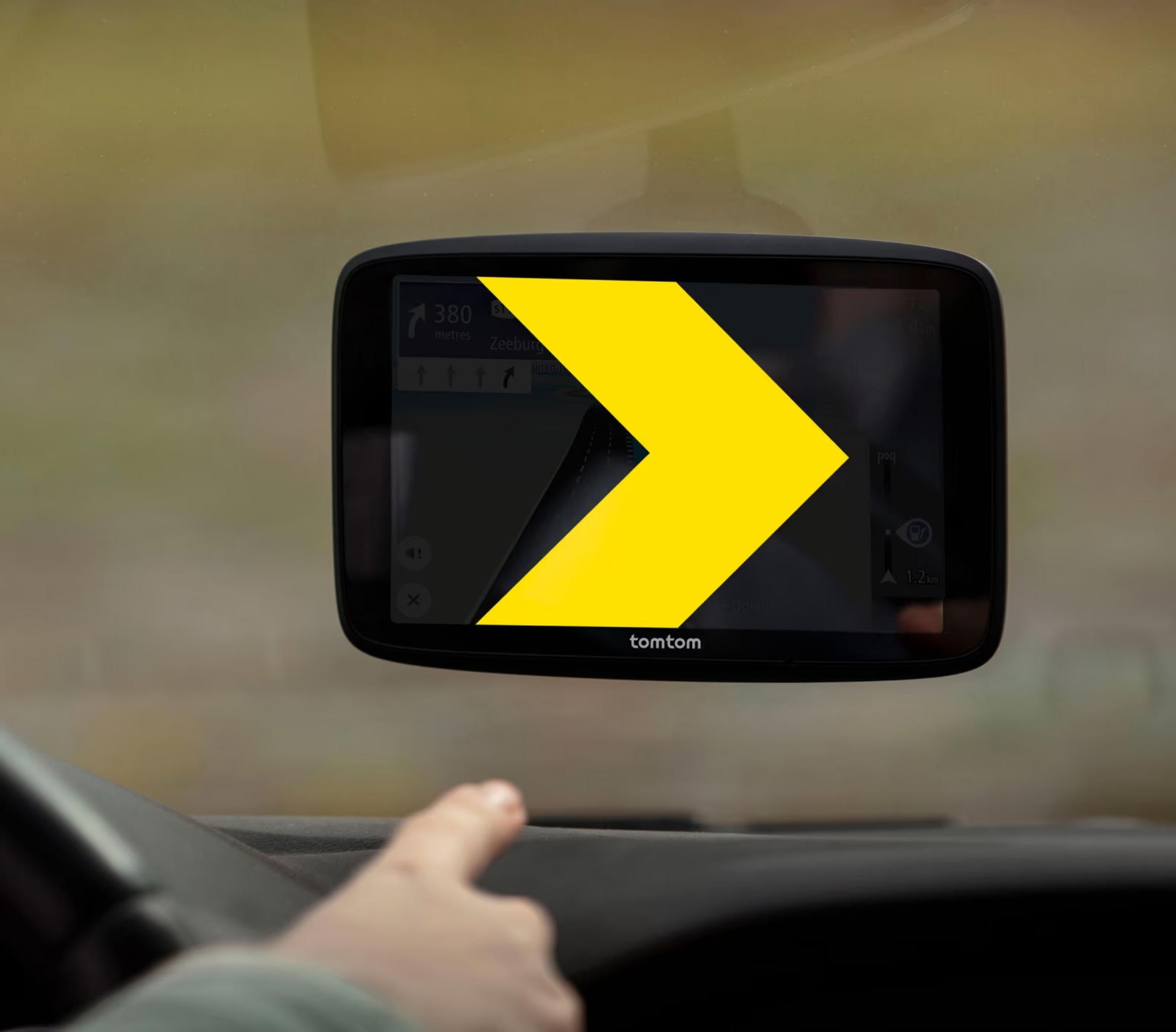 TomTom navigation device showing a yellow arrow on screen, indicating the route.