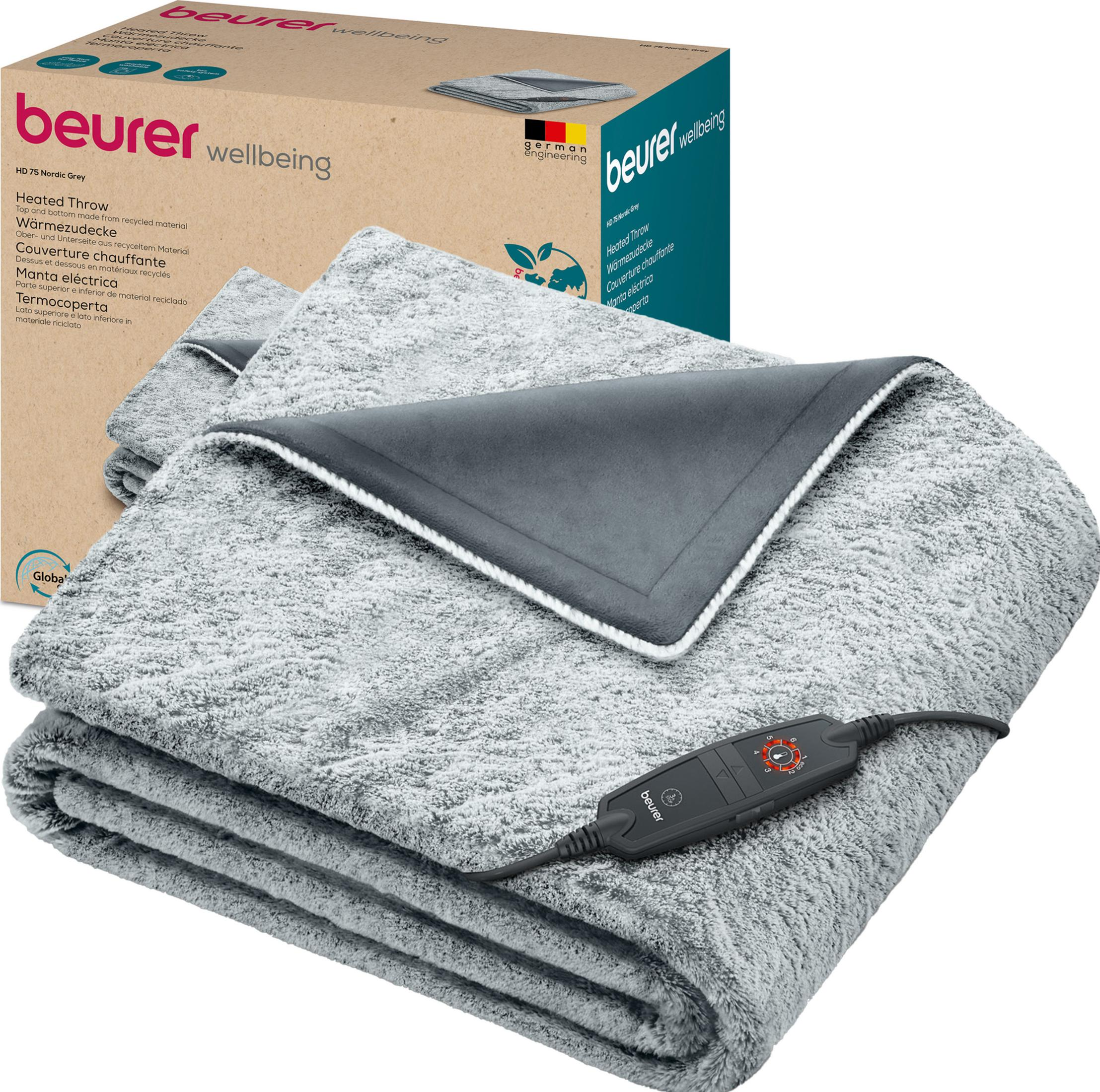 Grauer Beurer Heizwickel mit Fernbedienung und Verpackung.