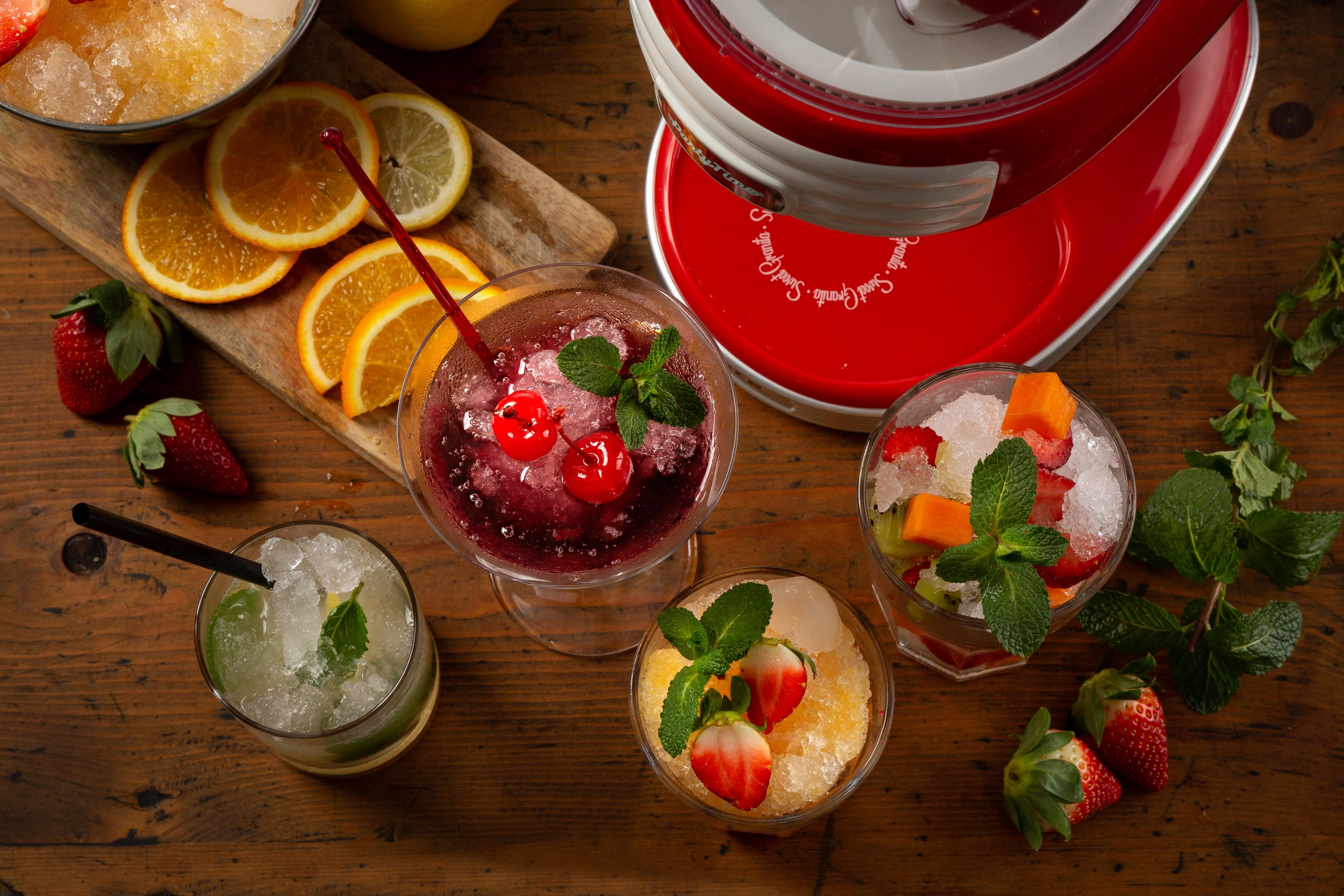 Frutta fresca, bevande ghiacciate e gelatiera su tavolo di legno.