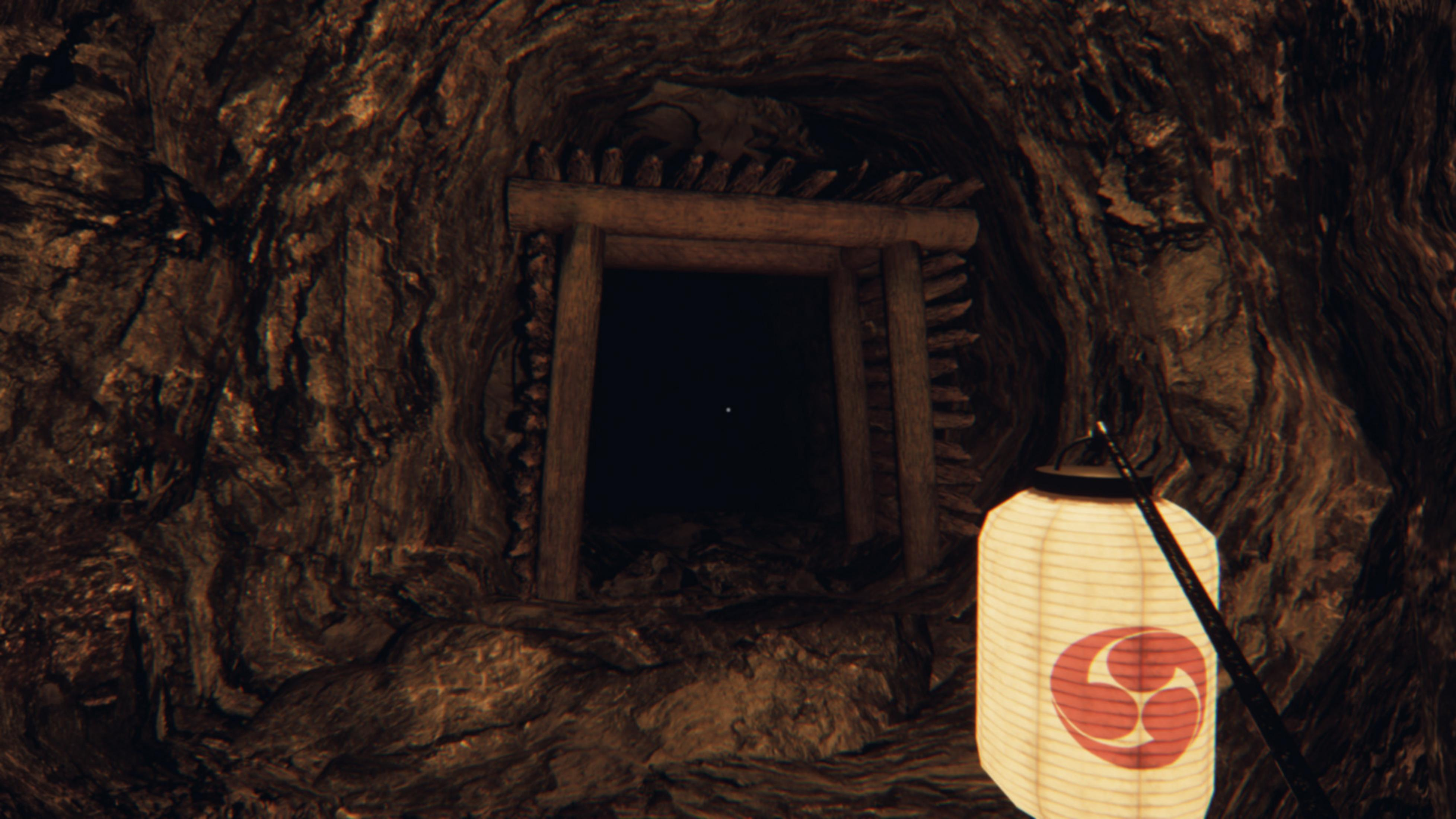 Una lanterna illumina una grotta con un cancello di legno.