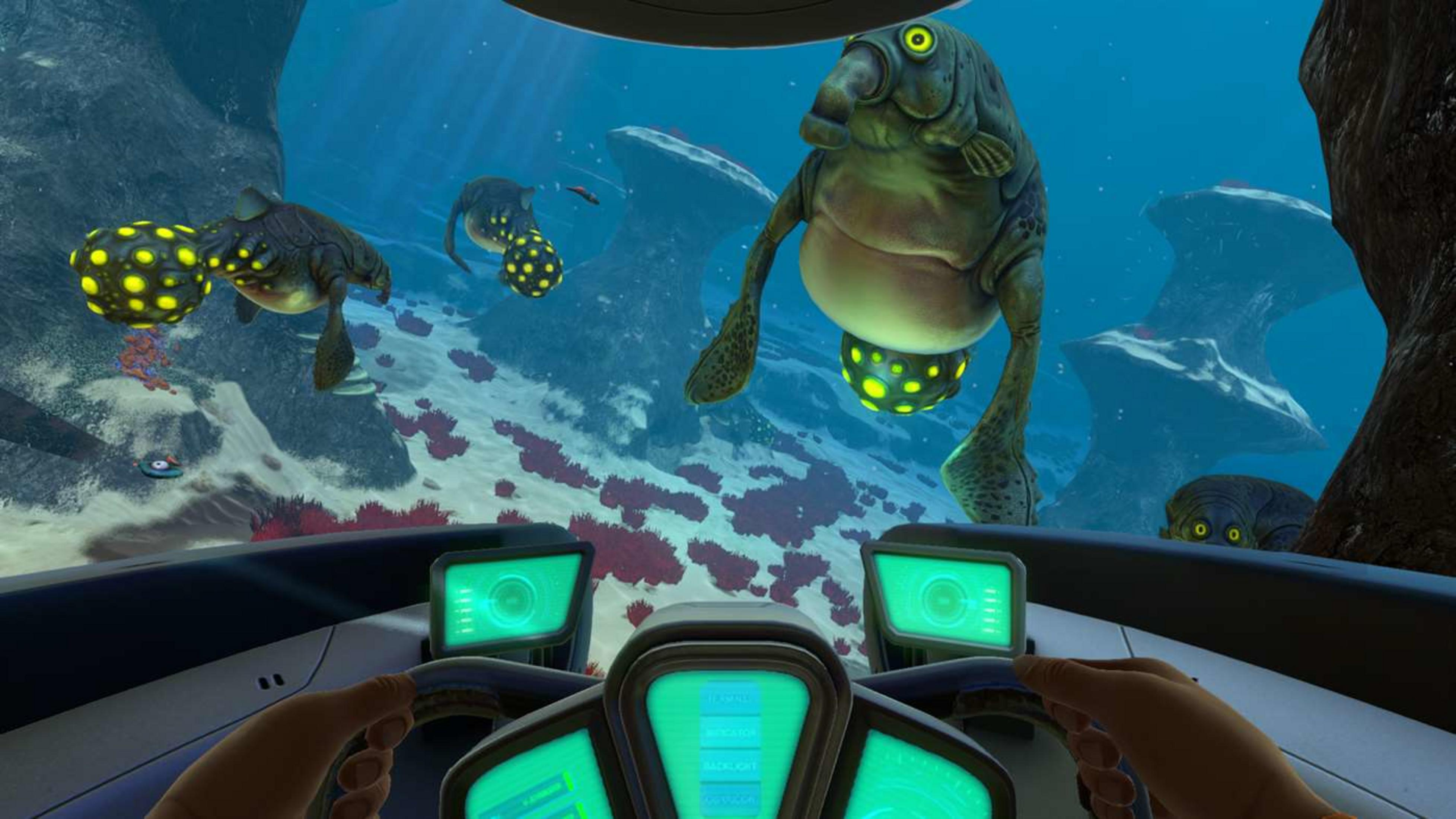 Ein U-Boot-Cockpit zeigt Unterwasserwesen und Felsen. Grüne Bildschirme leuchten.