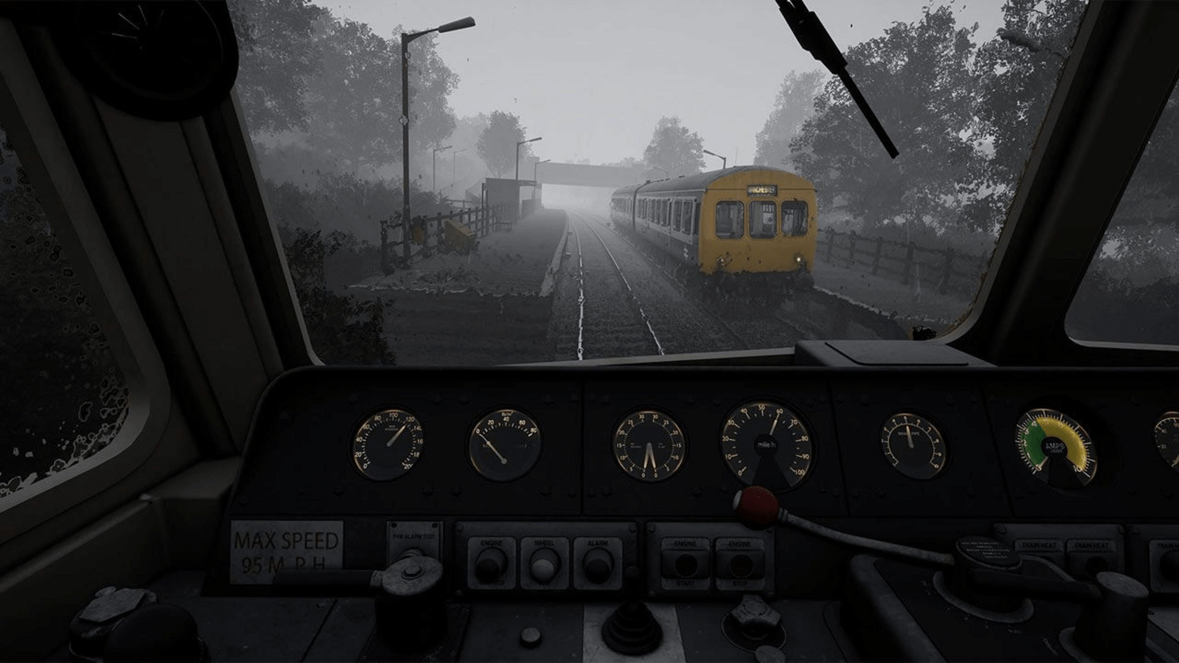 Blick aus einem Zugcockpit auf einen gelben Zug bei nebligem Wetter.