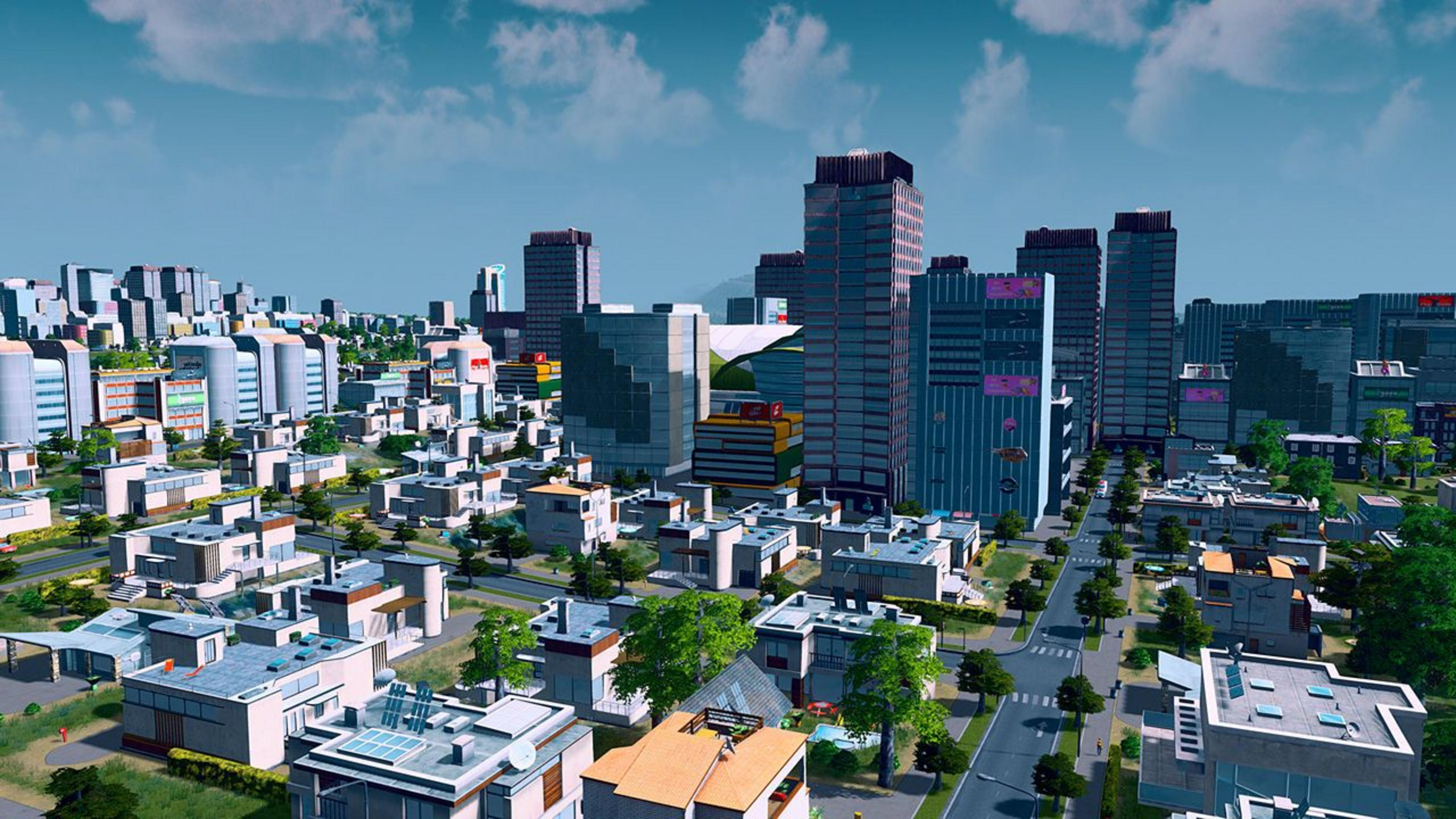 Eine weitläufige Stadtansicht mit vielen Gebäuden, Bäumen und Straßen.