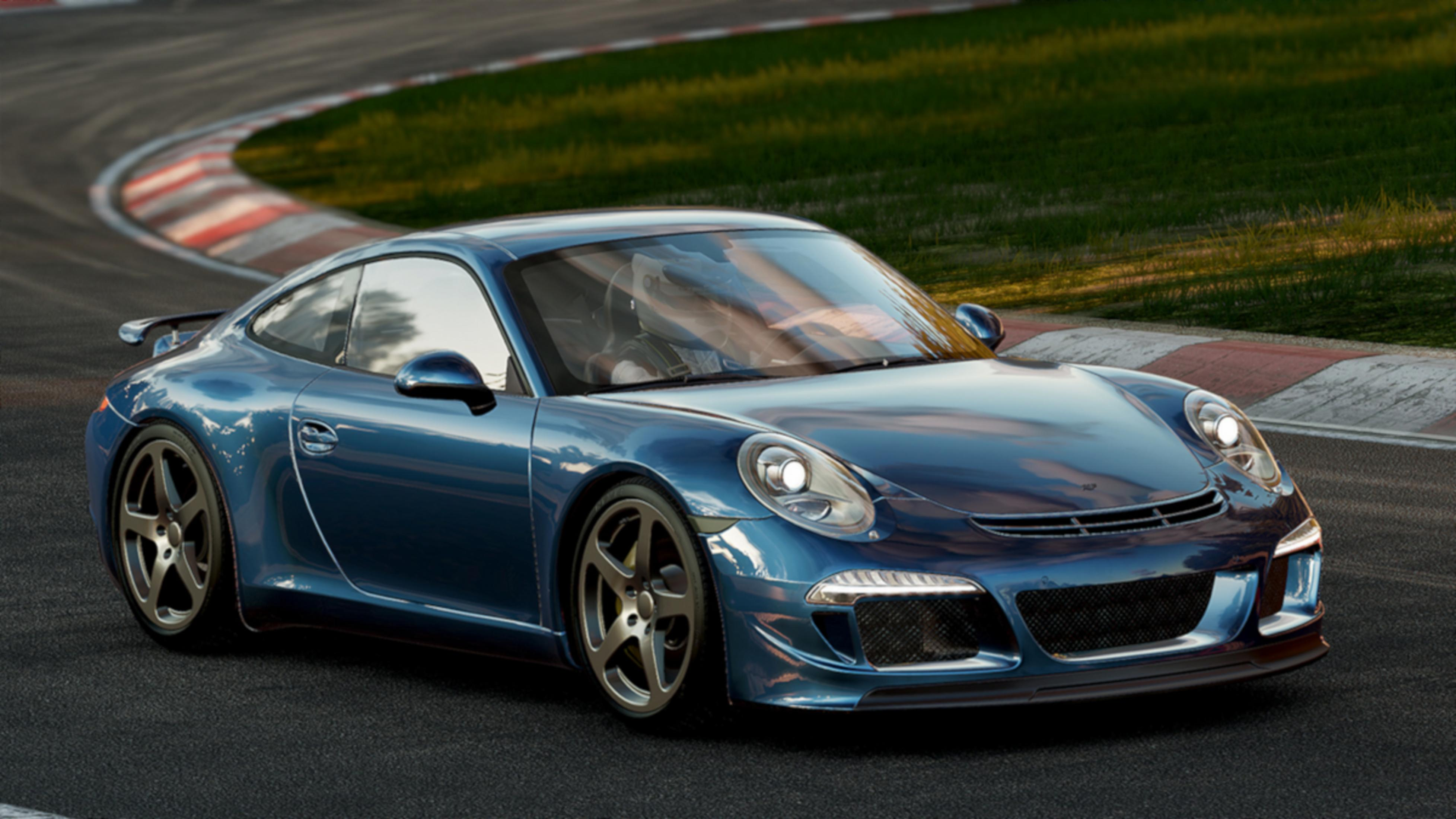 Ein blauer Porsche fährt auf einer Rennstrecke mit Gras und Leitplanken.