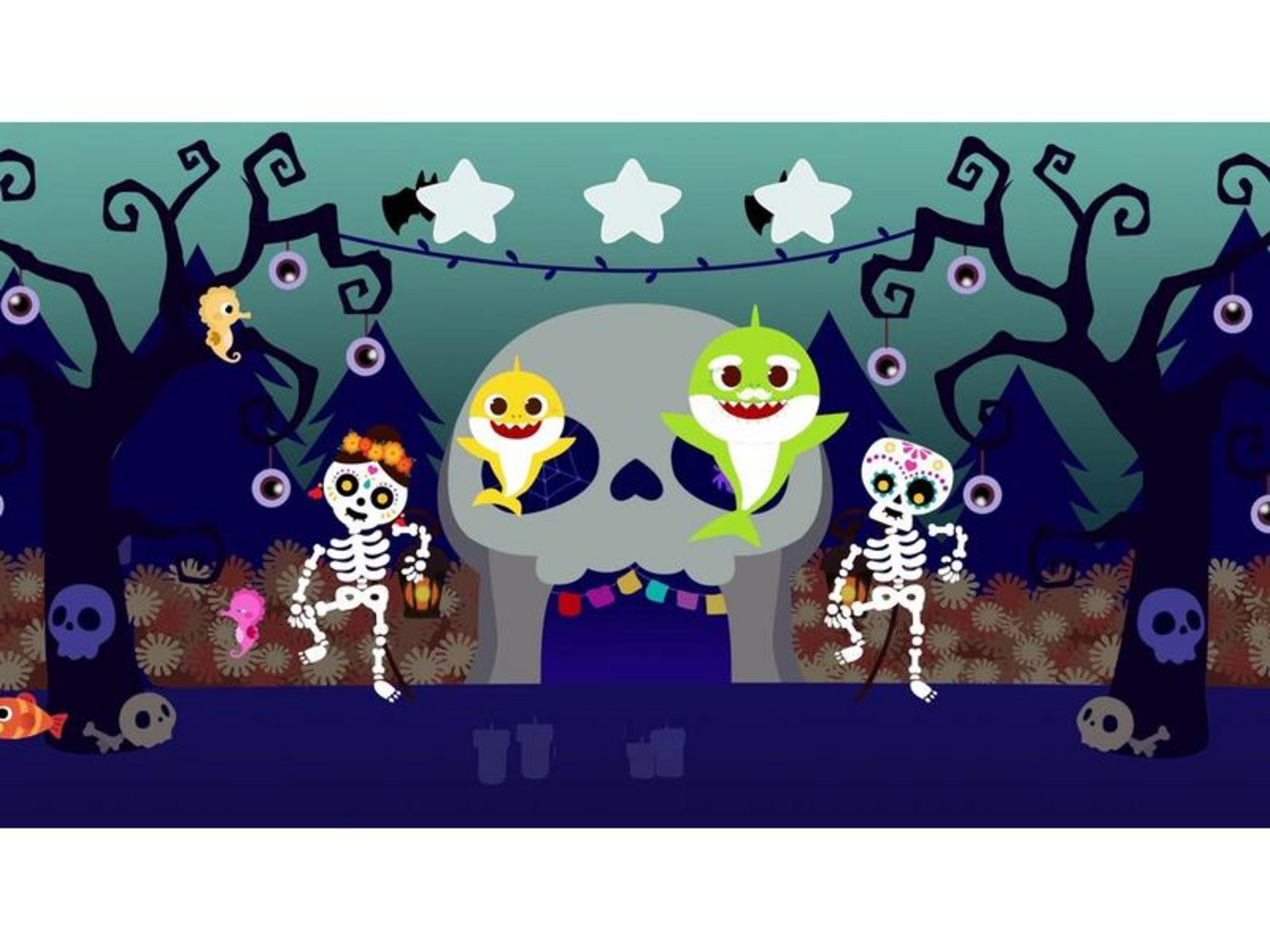 Scheletri e squali davanti a un teschio a una festa di Halloween.