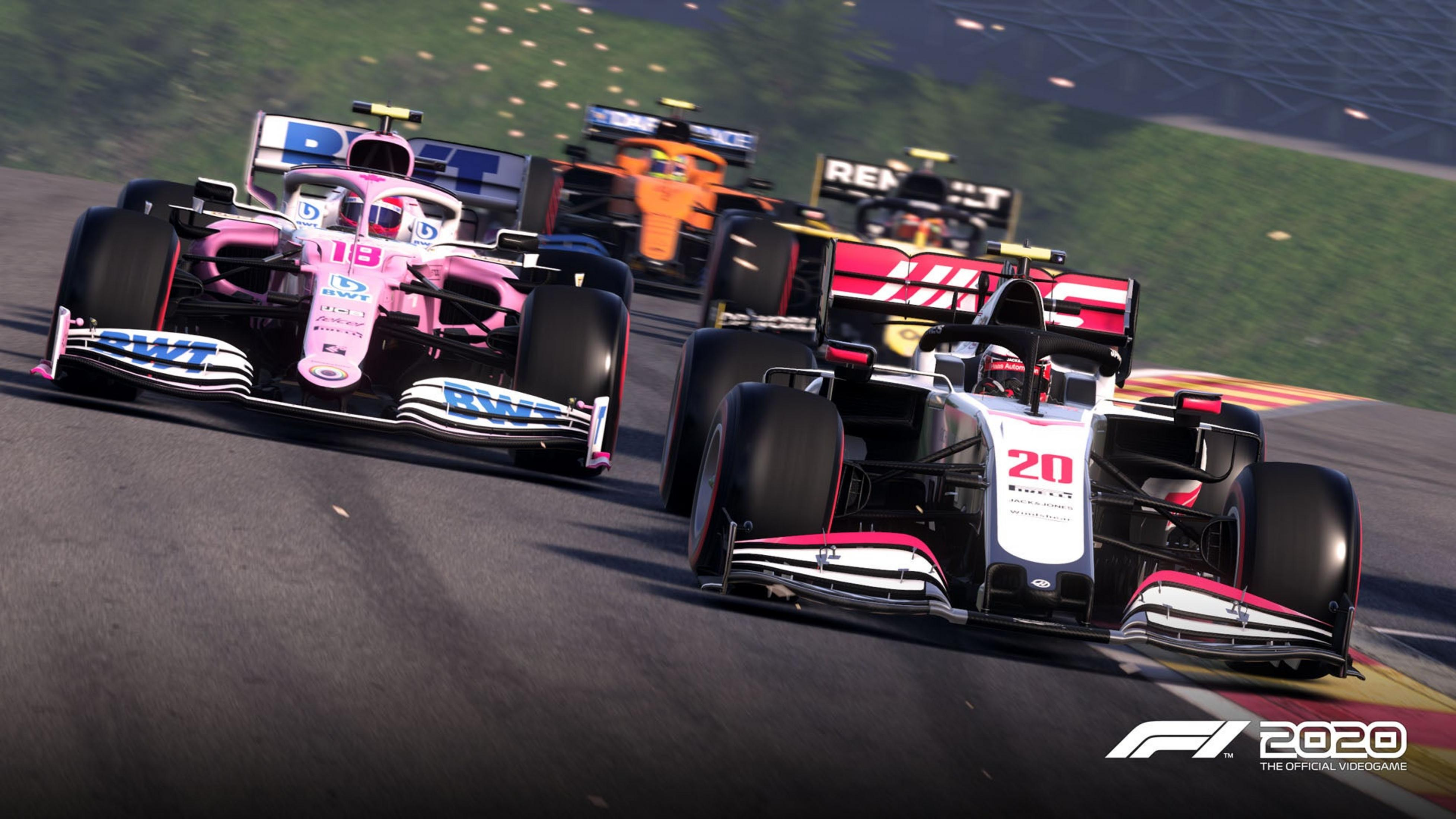 Formel-1-Autos rasen auf einer Strecke, eins ist pink, das andere weiß mit roter Schrift.