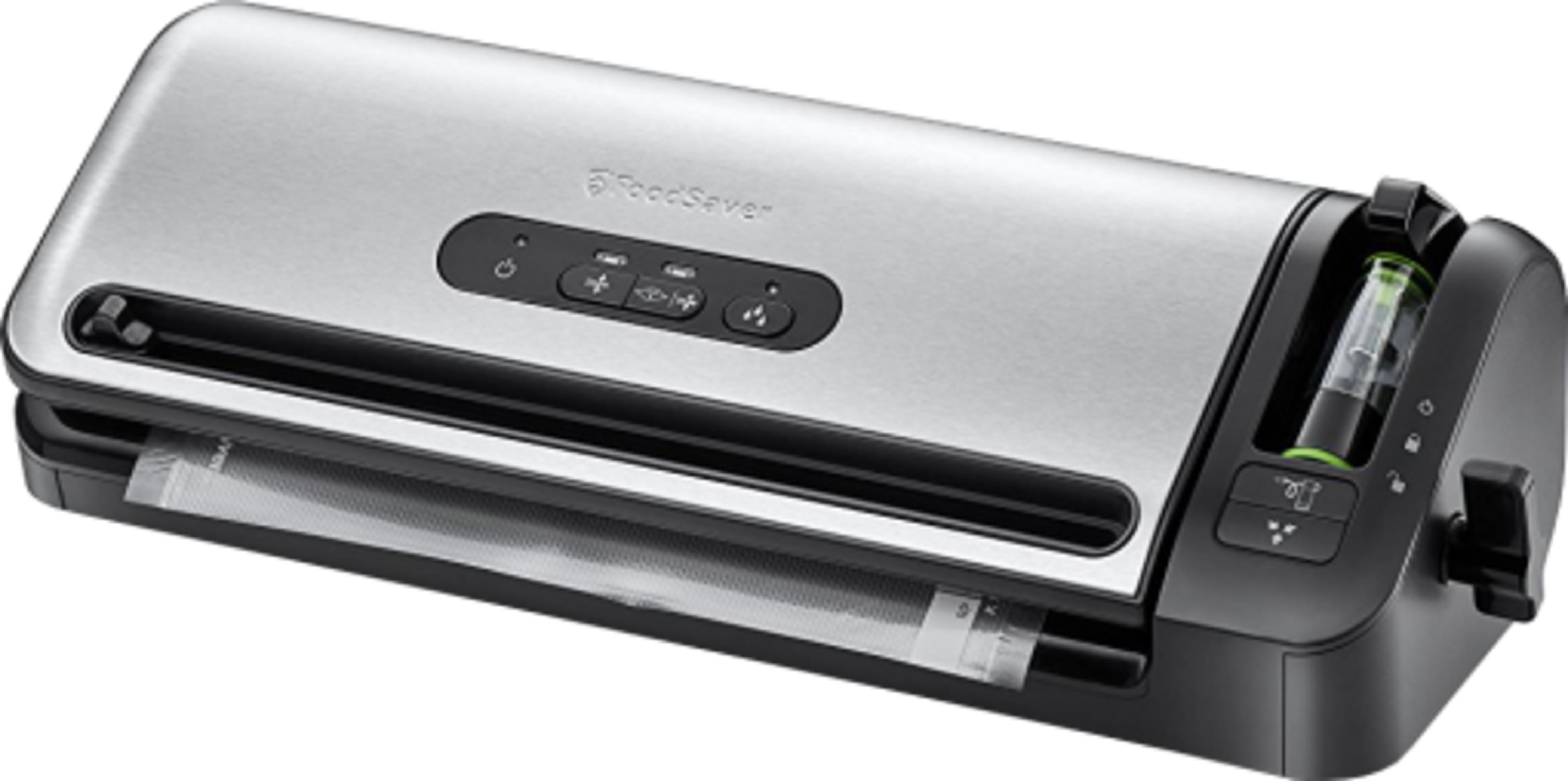 Srebrna zgrzewarka próżniowa z czarnymi przyciskami i przezroczystym pojemnikiem.