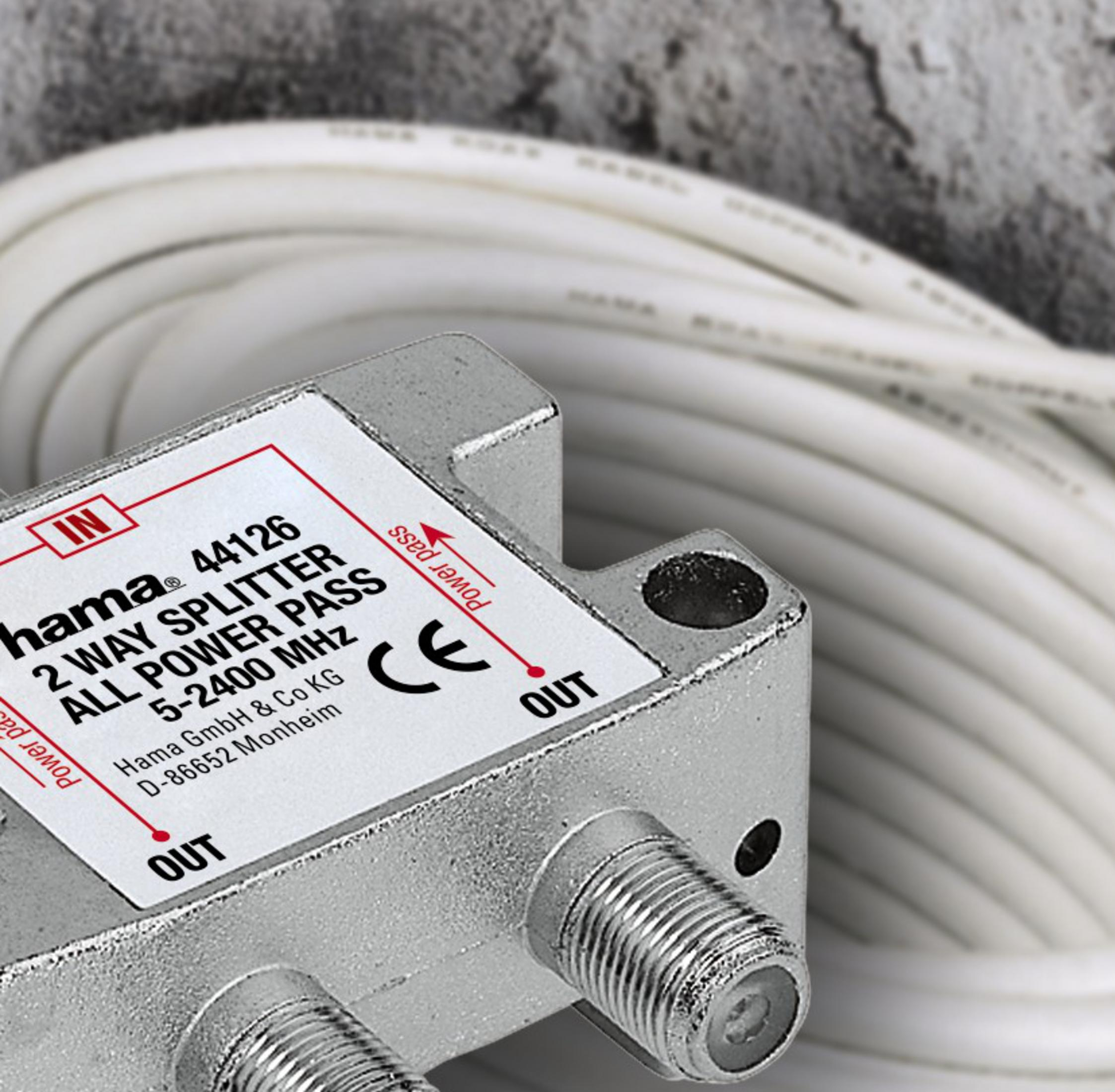 Ein Hama 2-Wege-Splitter mit Koaxialanschlüssen und weißem Kabel im Hintergrund.