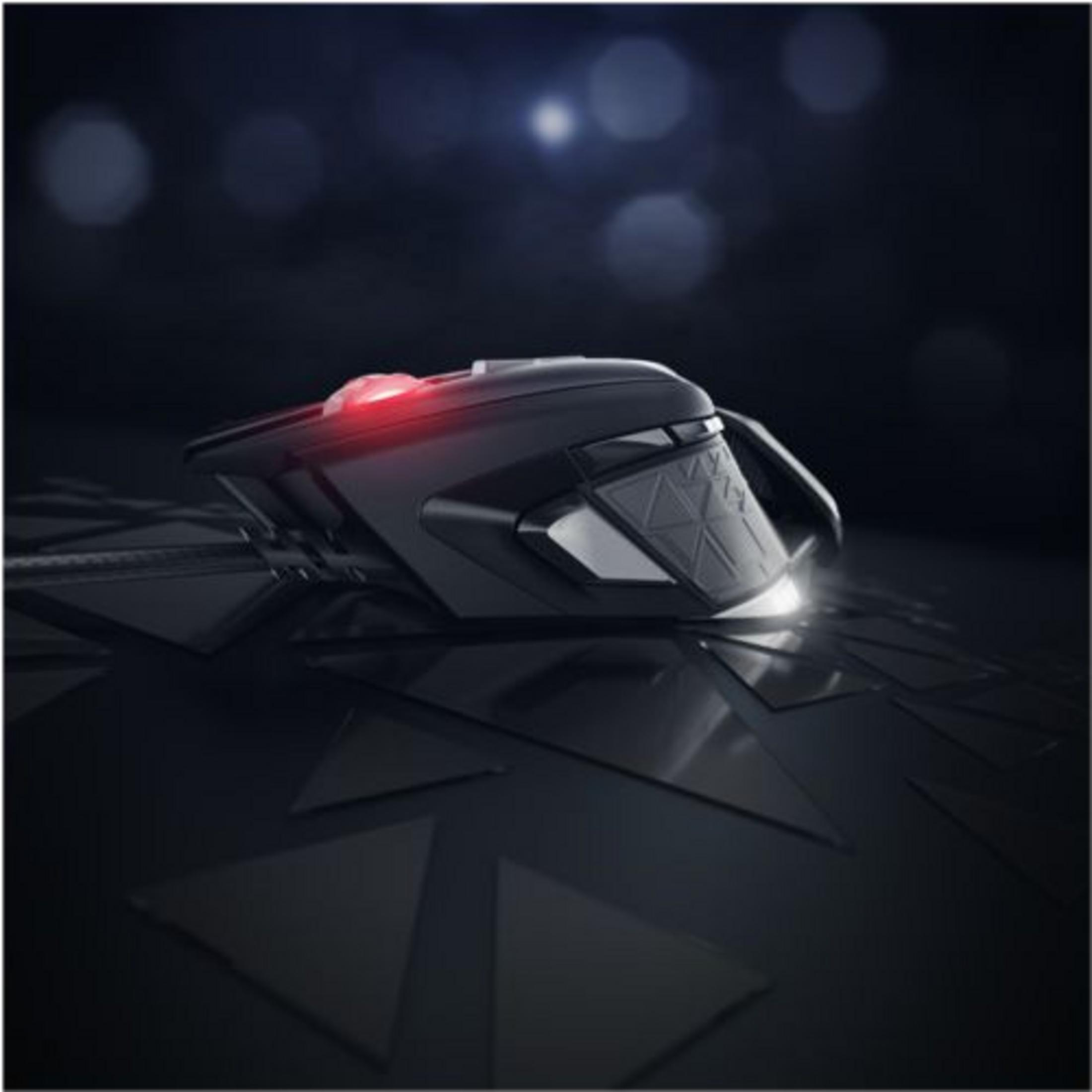 A black gaming mouse with red lighting rests on a dark, textured surface.