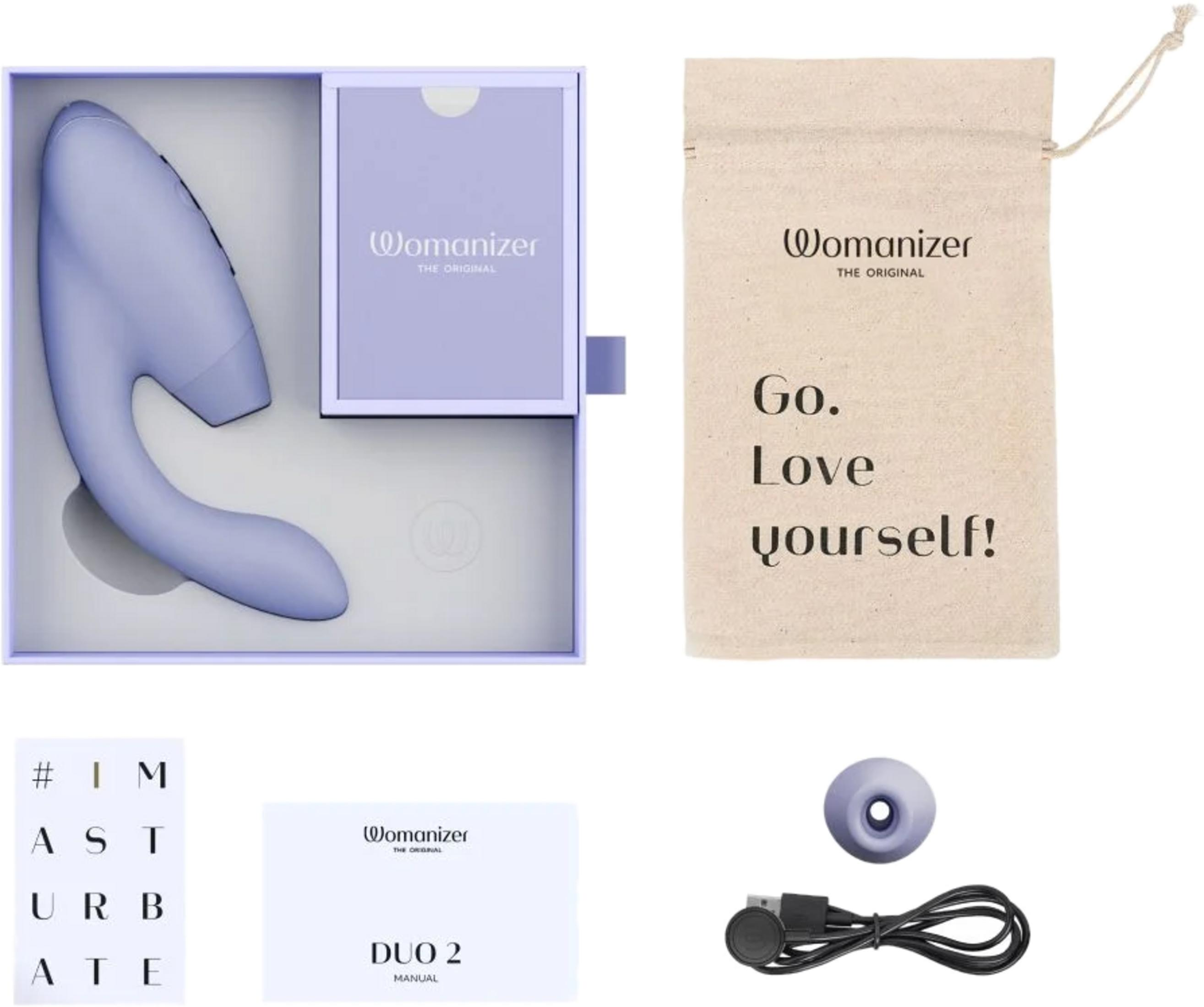 Un dispositivo morado claro en una caja, una bolsa con texto, un manual y cables.