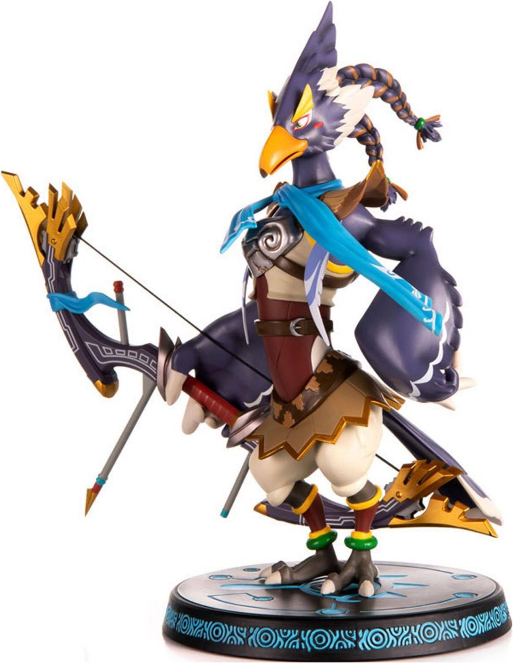 Une figurine d'oiseau tenant un arc et une flèche, sur un socle.