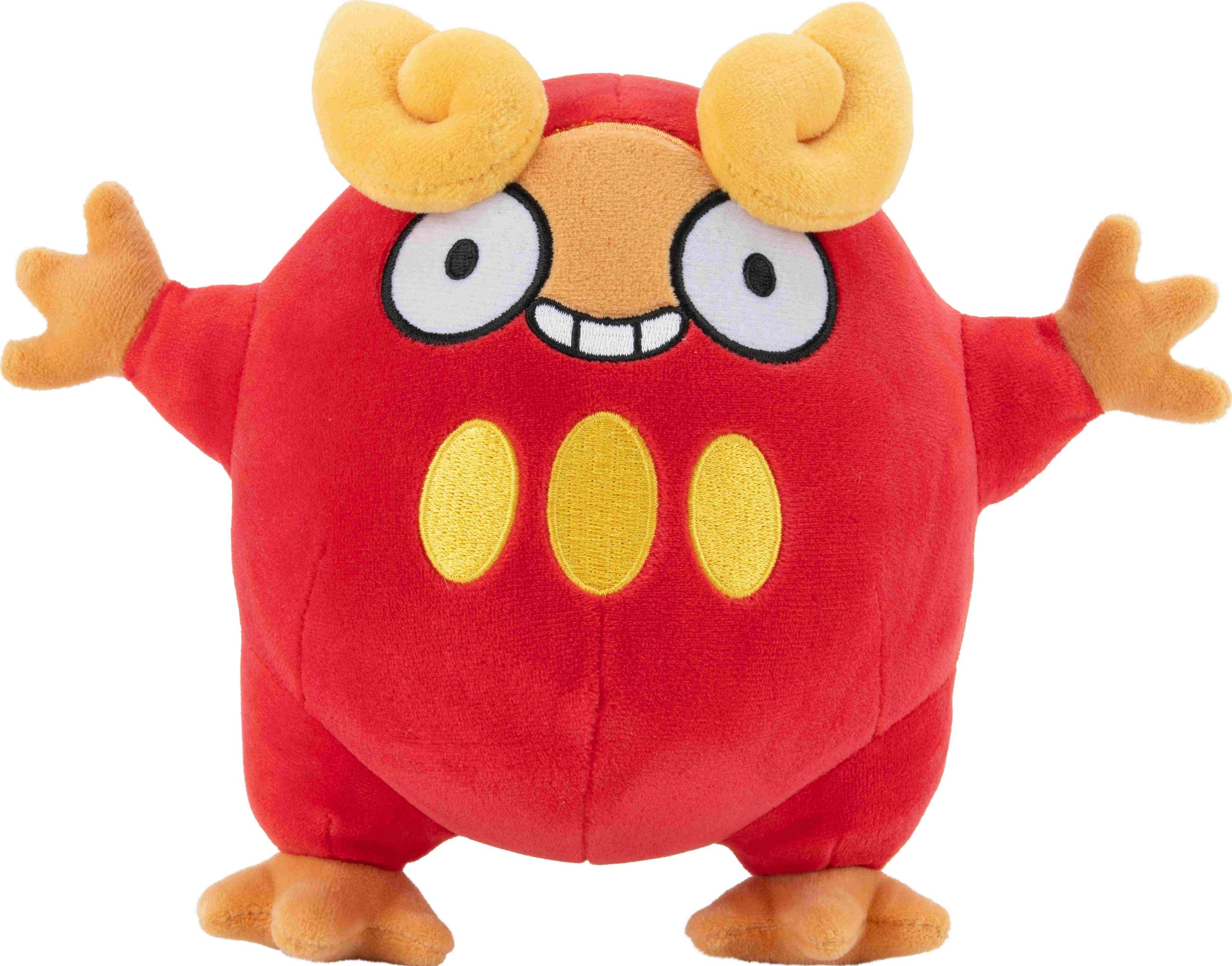 Un peluche rosso con corna, occhi e macchie gialle.