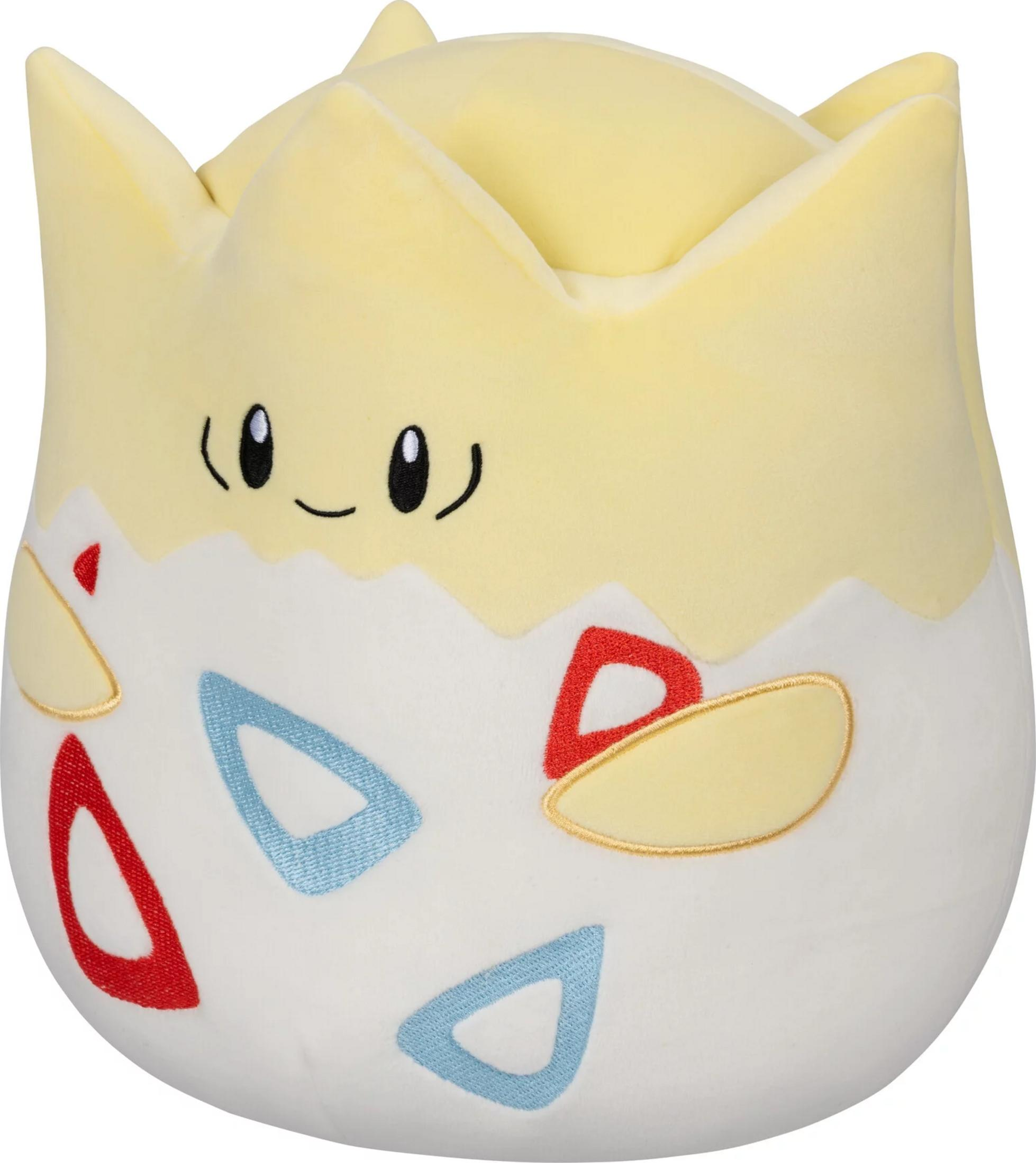 Un peluche Togepi giallo con corpo bianco a forma di uovo e triangoli rossi/blu.