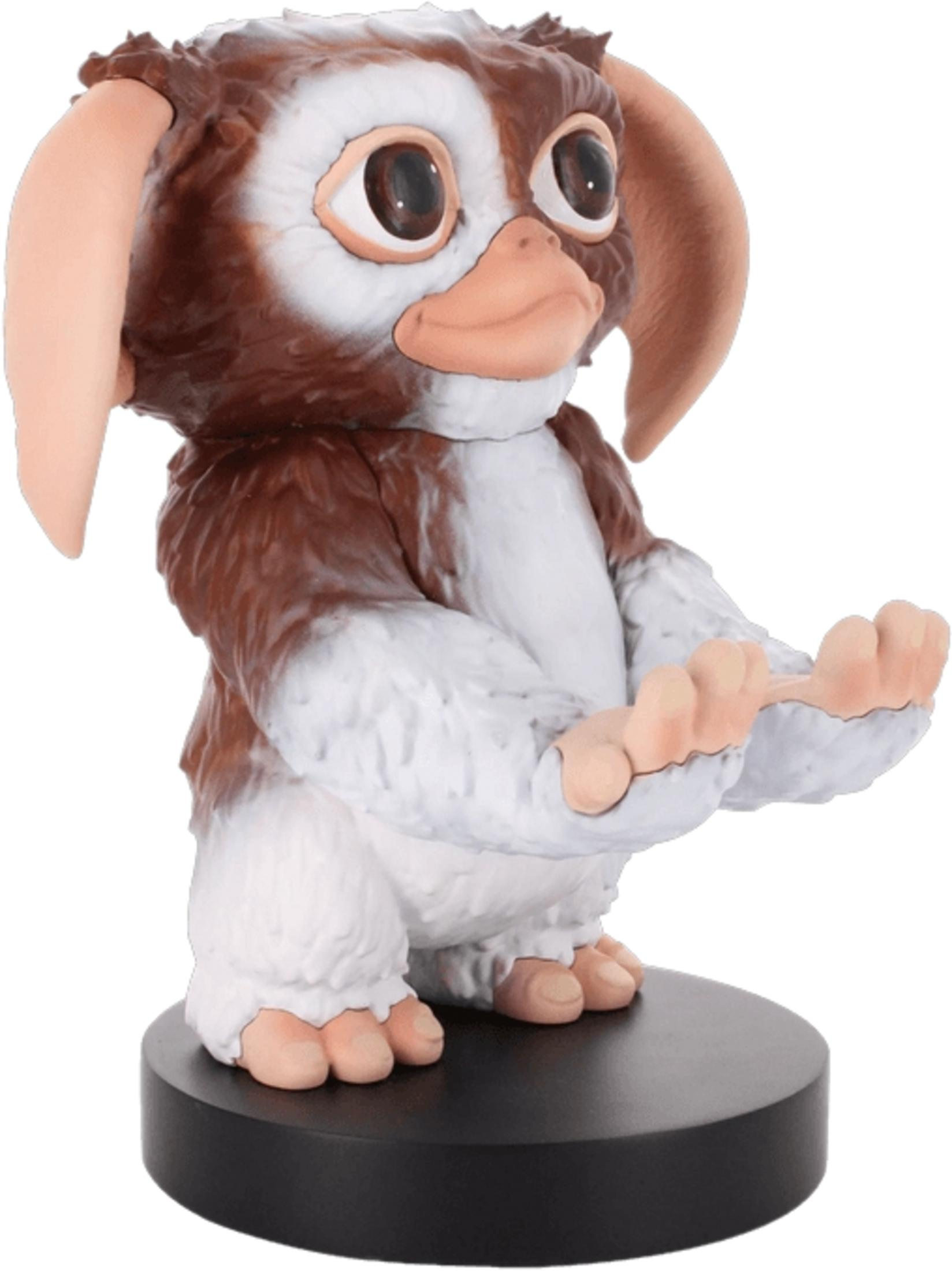 Eine braun-weiße Gremlin-Figur mit großen Ohren und Händen, die nach vorne gehalten werden.