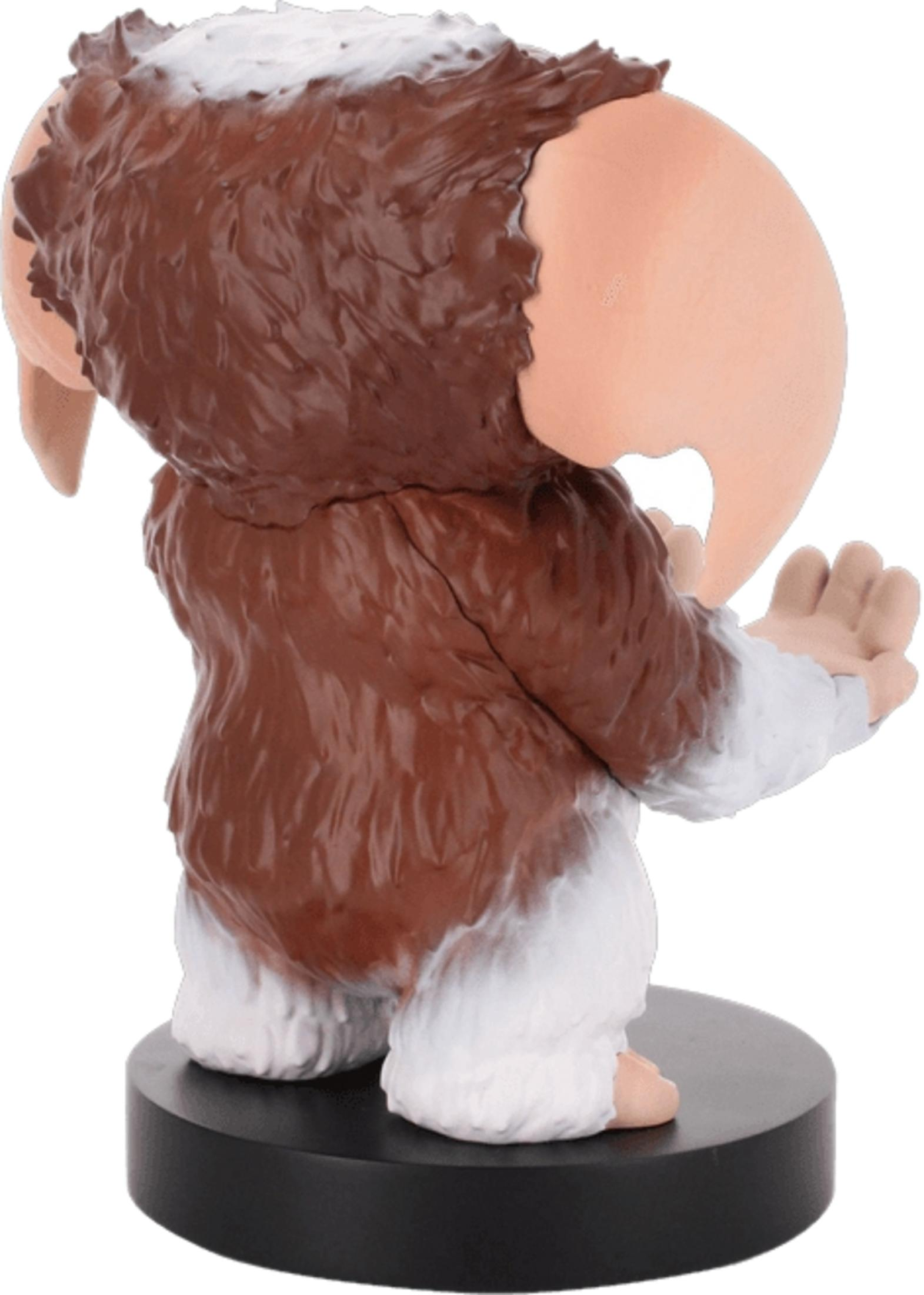 Figur eines braunen und weißen Wesens mit großen Ohren auf schwarzer Basis.