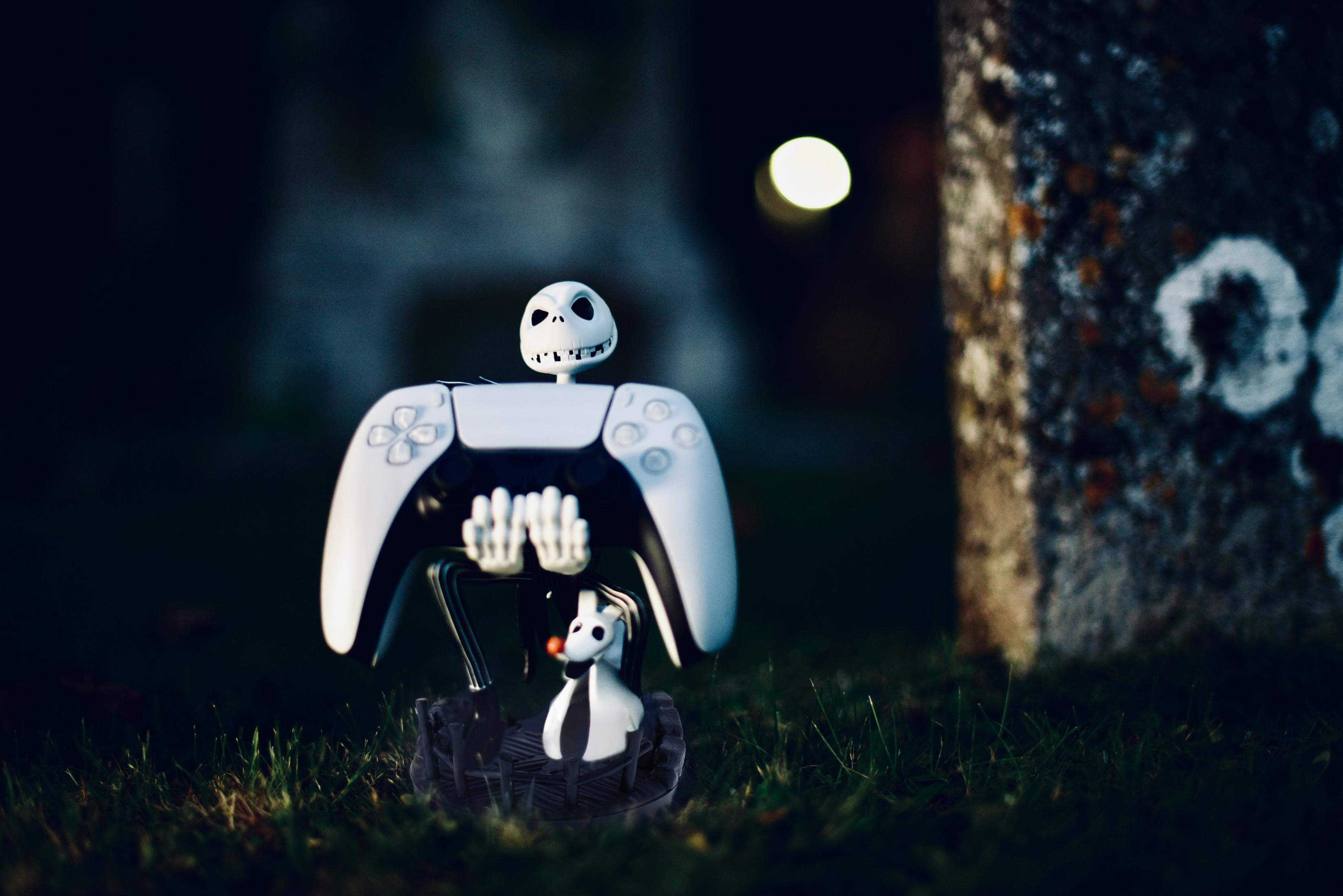 Figura di Jack Skellington con controller bianco in ambiente scuro.