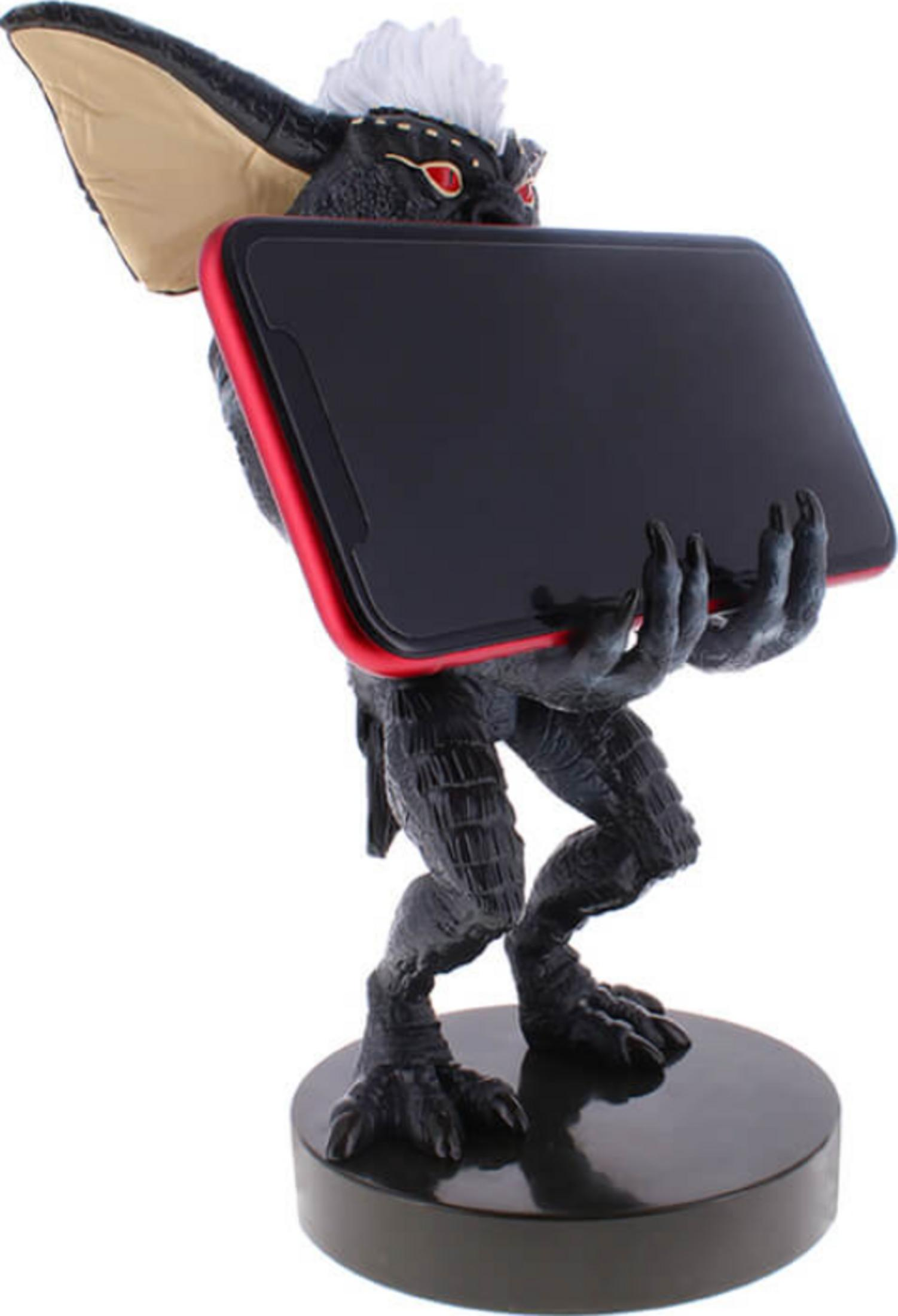 Statua di Gremlin che tiene uno smartphone con bordo rosso e schermo nero.