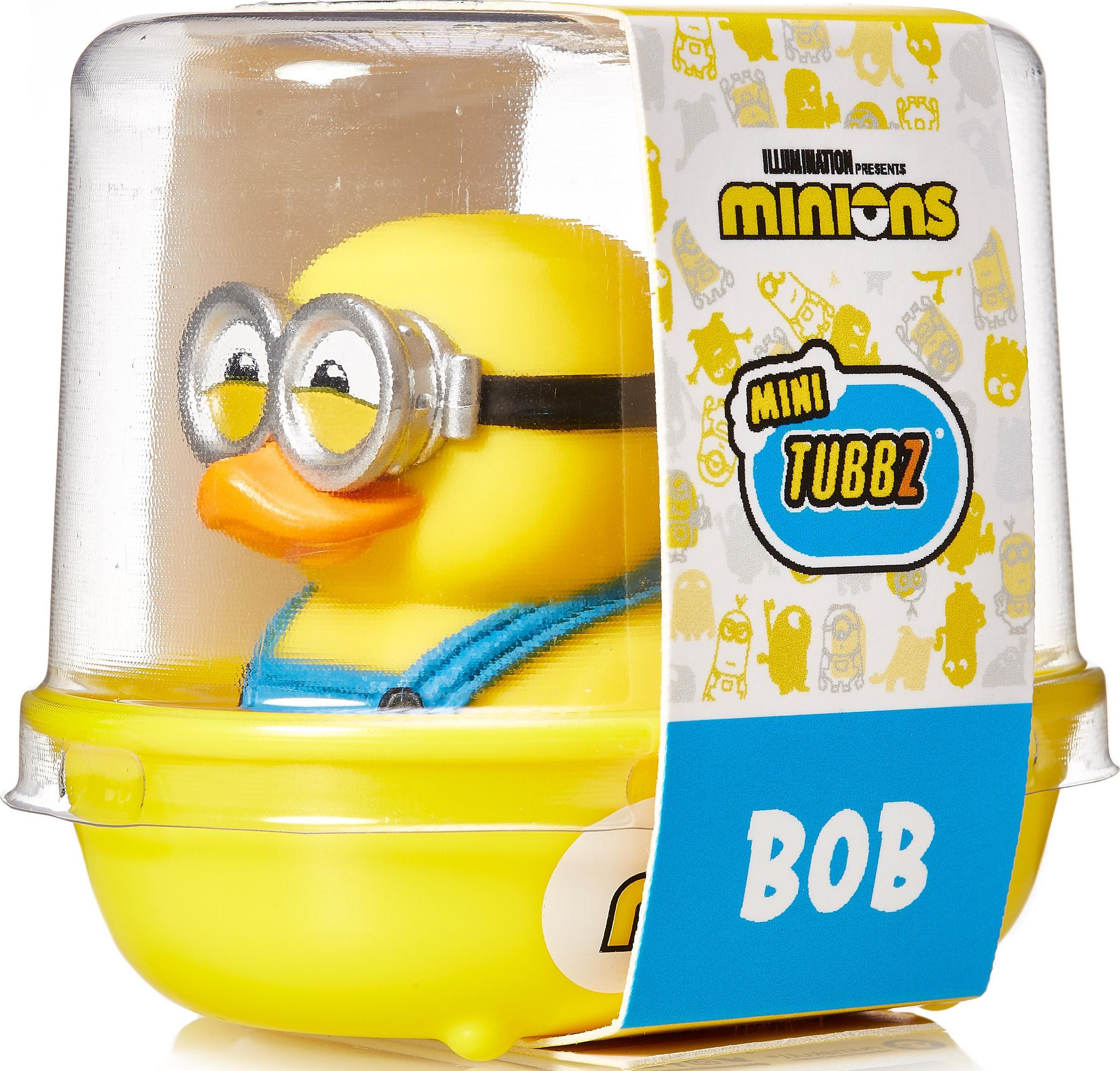 Eine gelbe Quietscheente mit Minion-Brille und blauer Latzhose in einer Verpackung.
