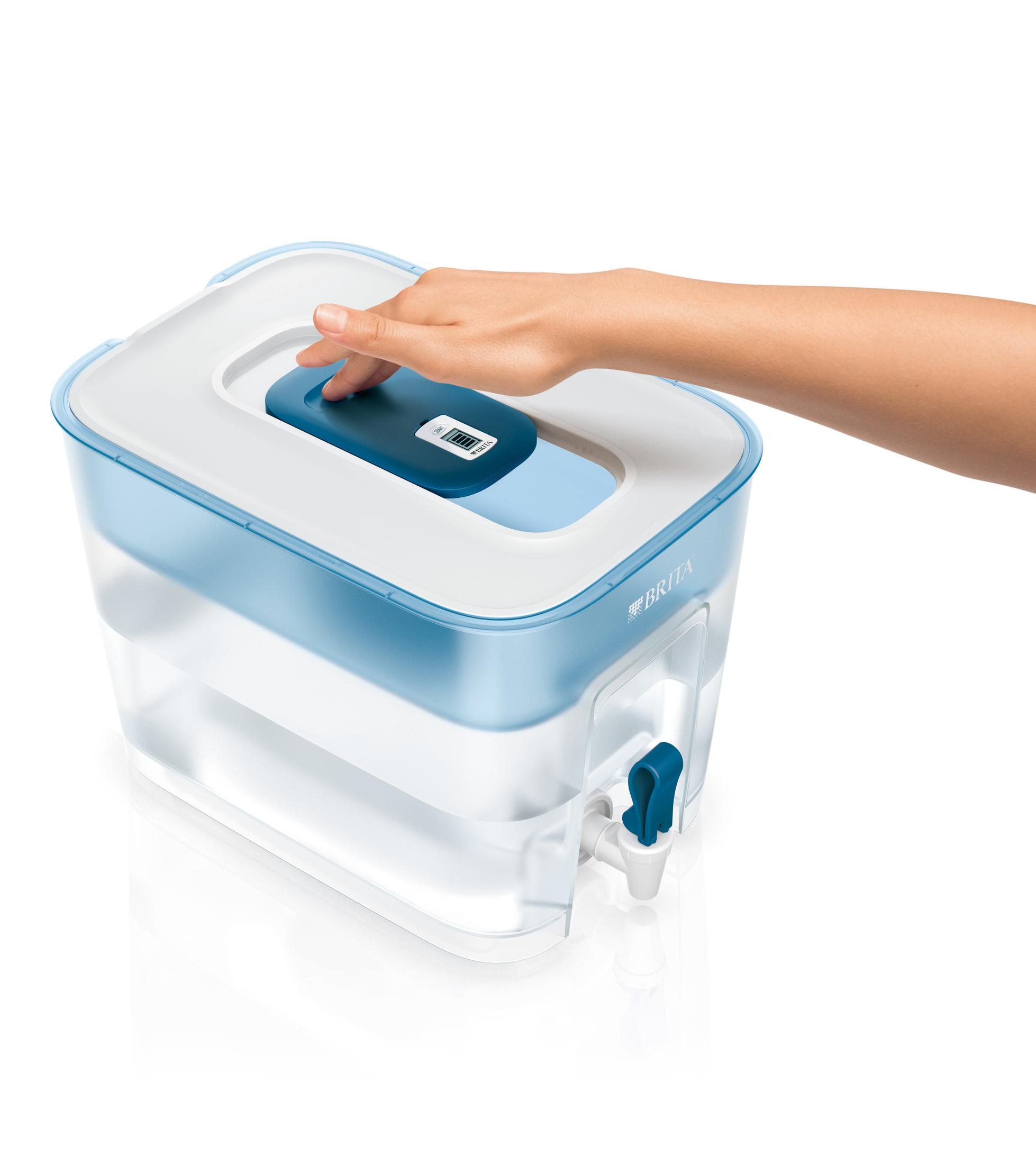 A hand presses a blue button on a Brita water filter pitcher with a spigot.