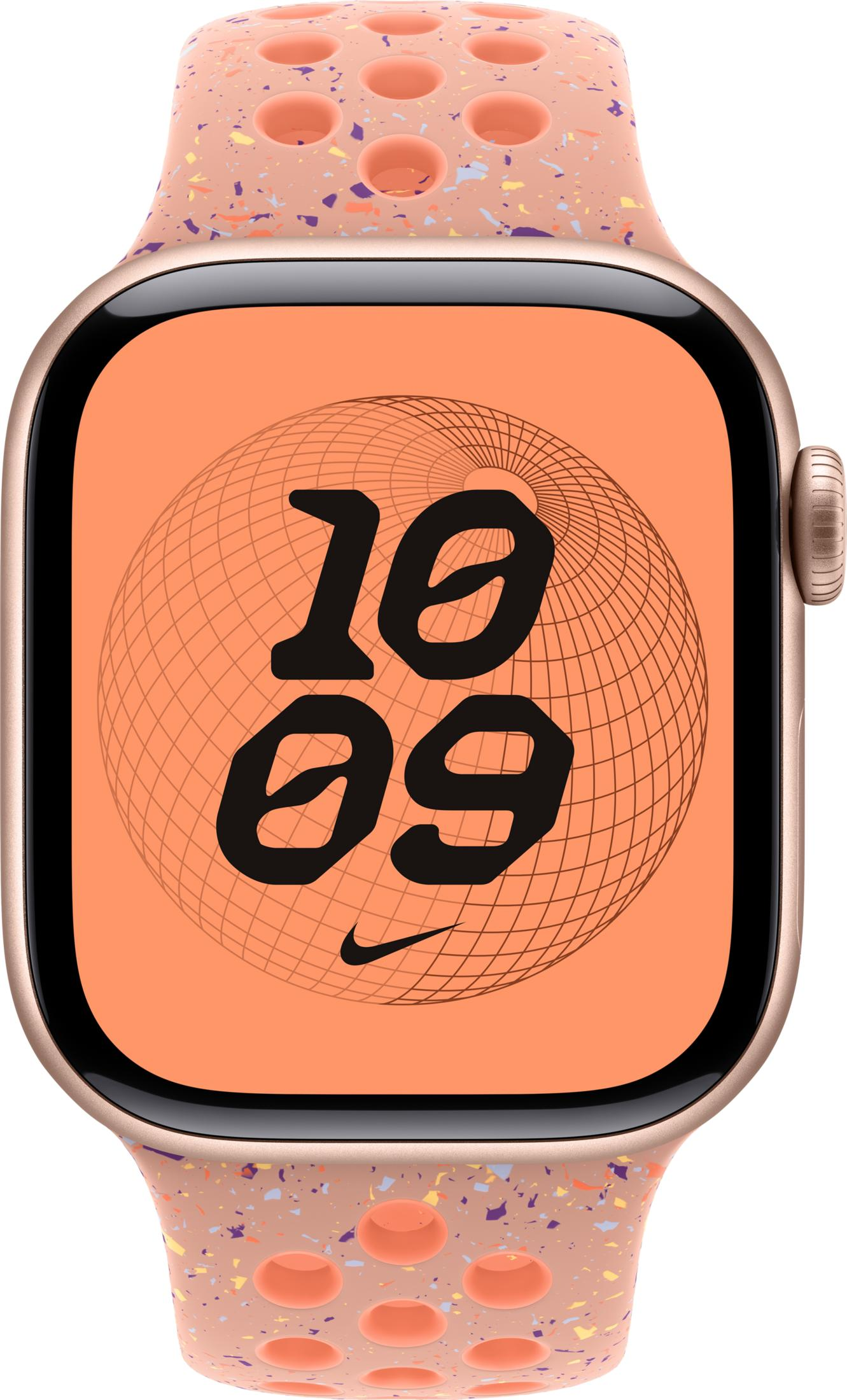 Złoty Apple Watch w brzoskwiniowej opasce w plamki z tarczą zegara.