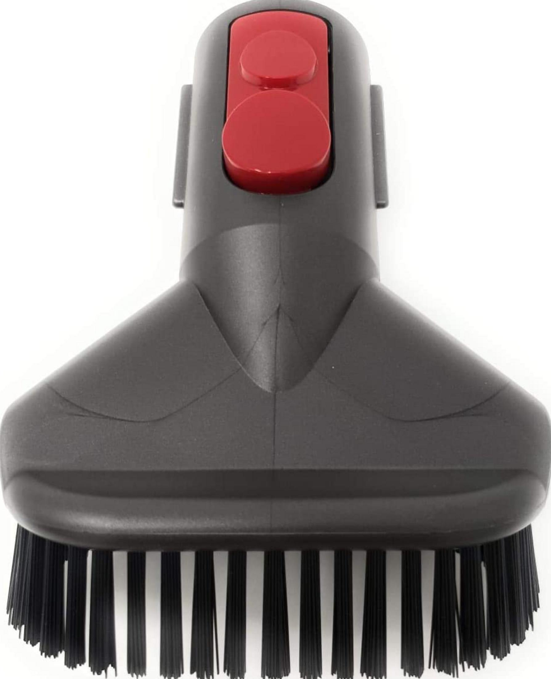 Accessorio aspirapolvere grigio con pulsanti rossi e setole nere.