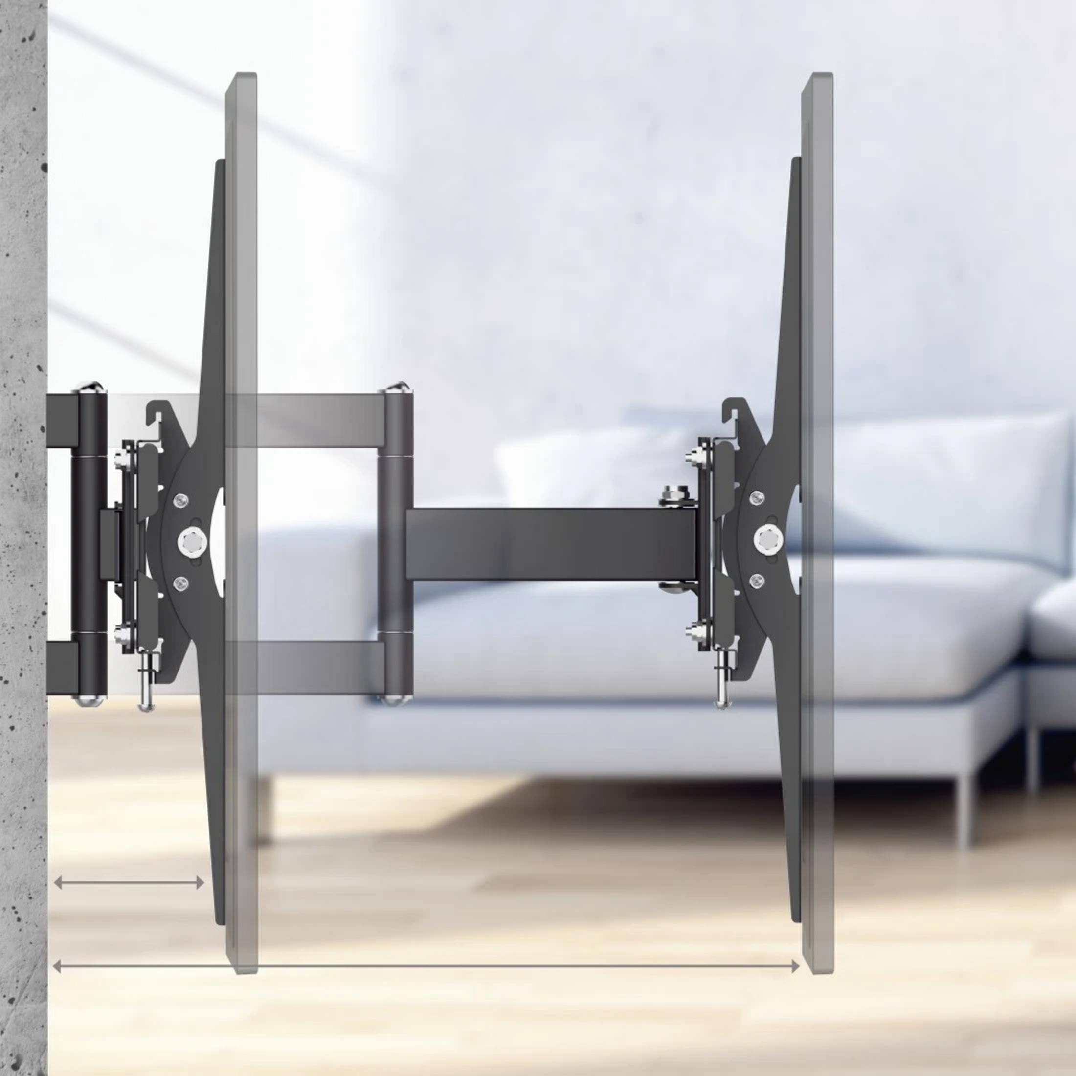 Ein ausziehbarer Fernsehhalter an einer Betonwand, mit einem Sofa im Hintergrund.