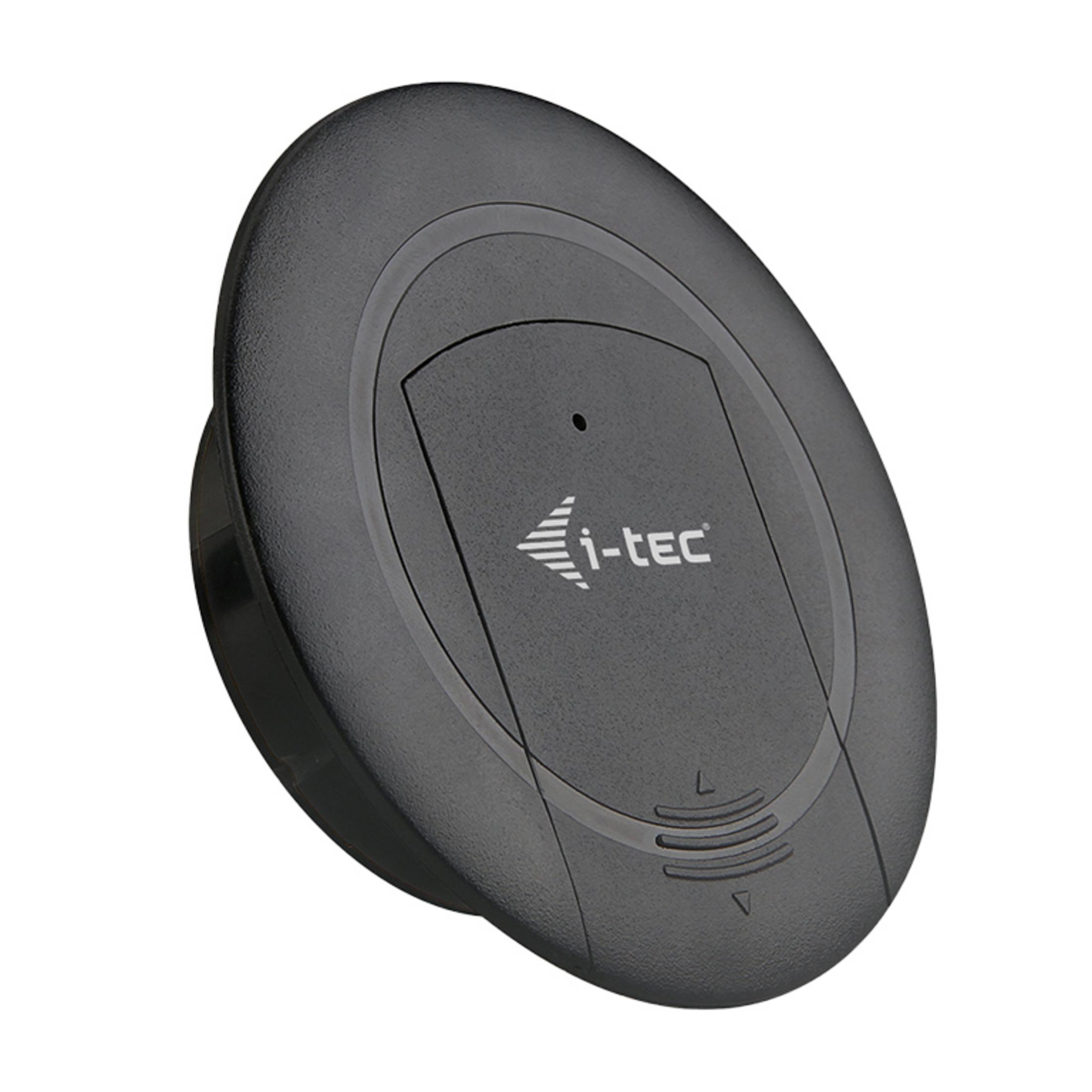 Un appareil rond noir i-tec avec un symbole de flèche et des fentes d'aération.