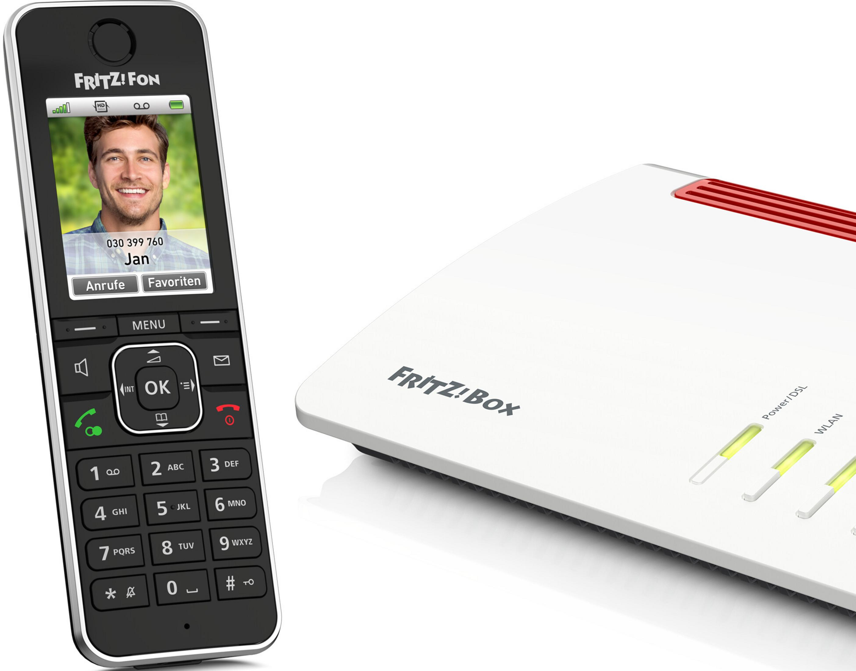 A Fritz Fon phone sits next to a white Fritz!Box router.