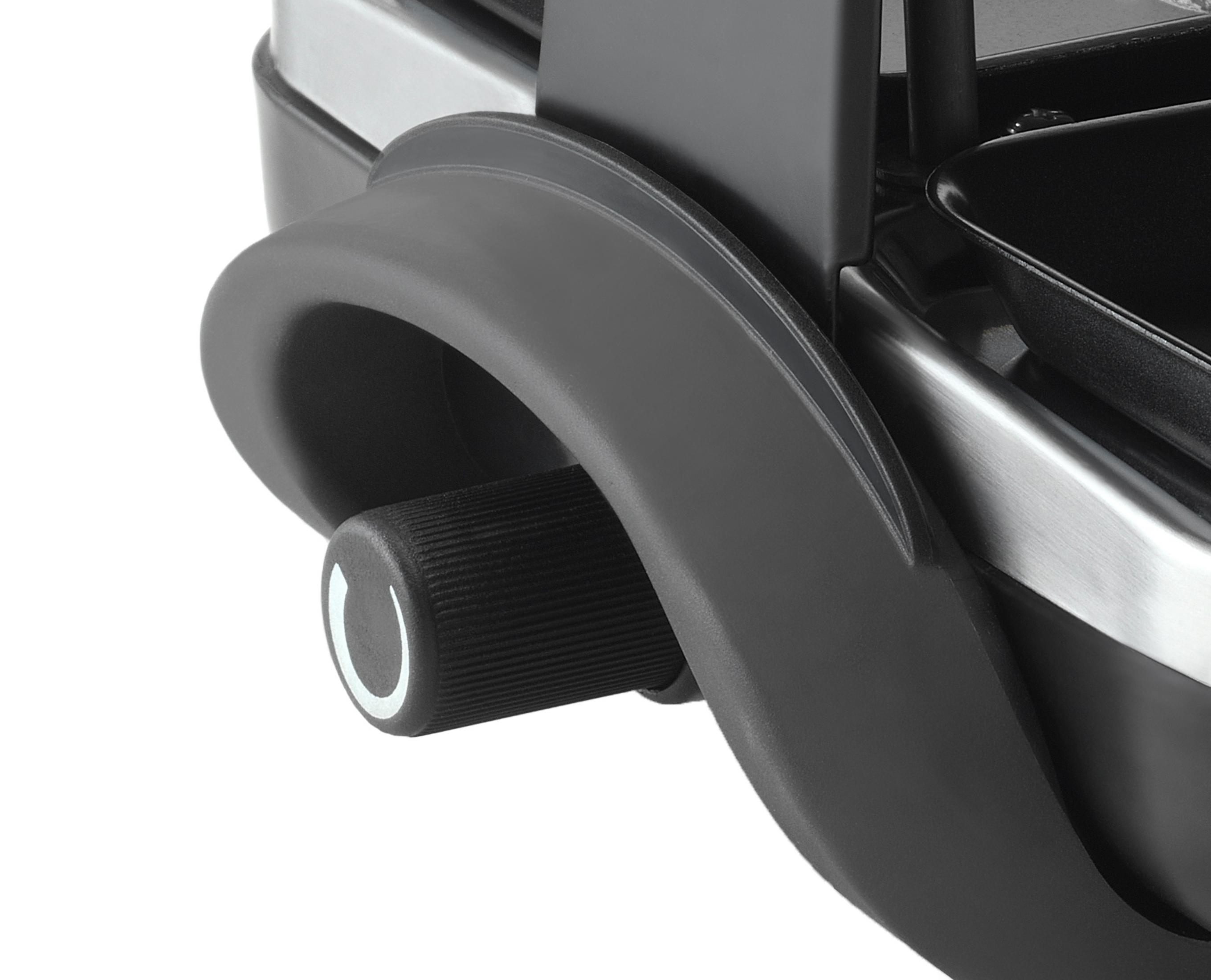 Zbliżenie czarnego pokrętła z białym oznaczeniem na urządzeniu.