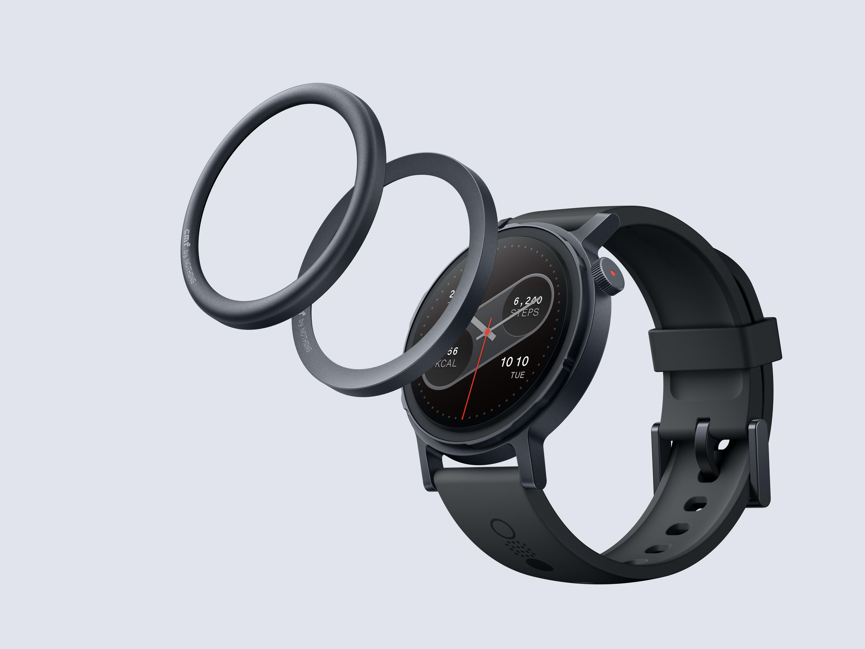 Czarny smartwatch z pierścieniami otaczającymi ekran. Wyświetla kroki i kalorie.