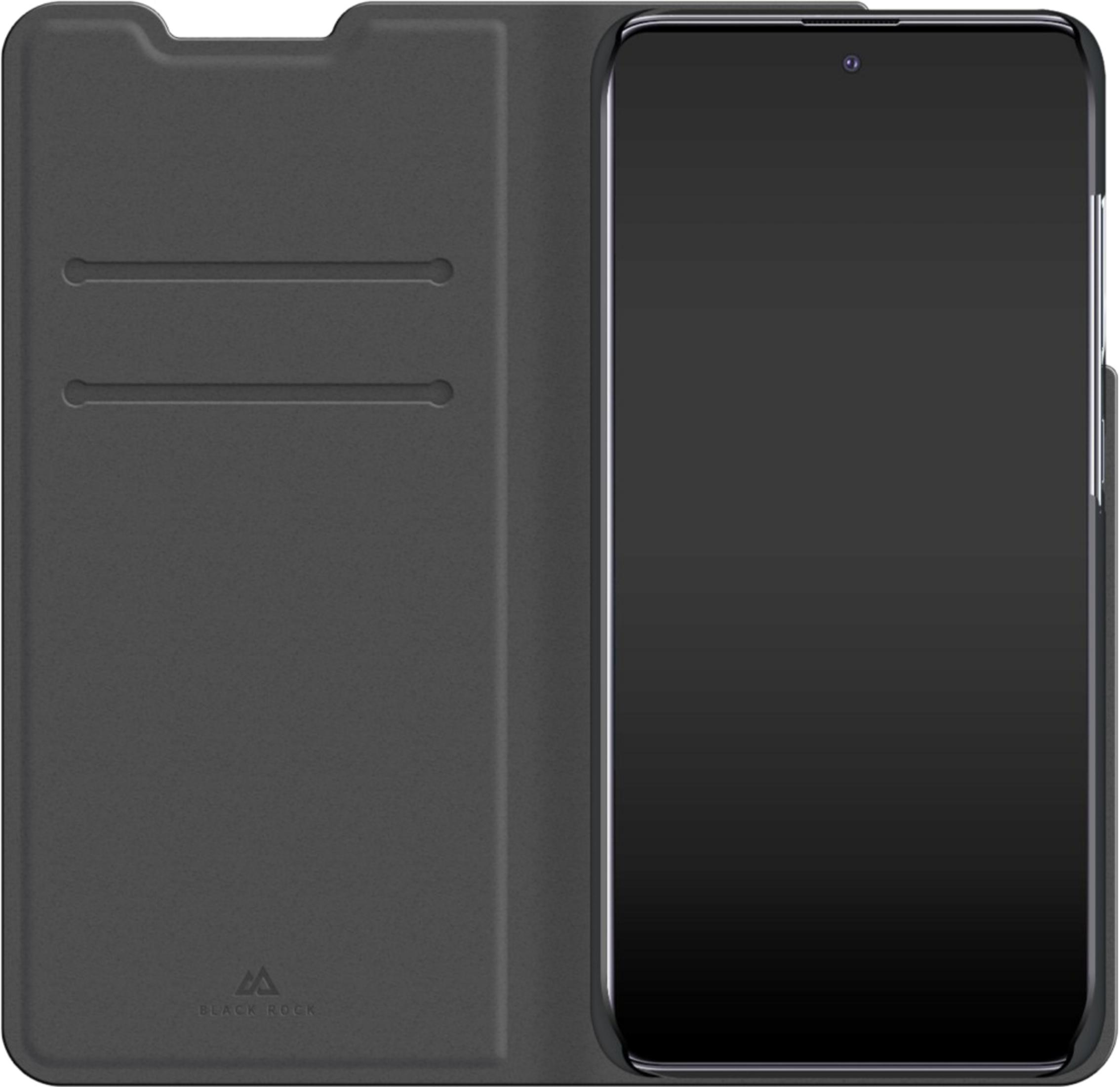 Uno smartphone nero all'interno di una custodia a libro aperta con due slot per carte.