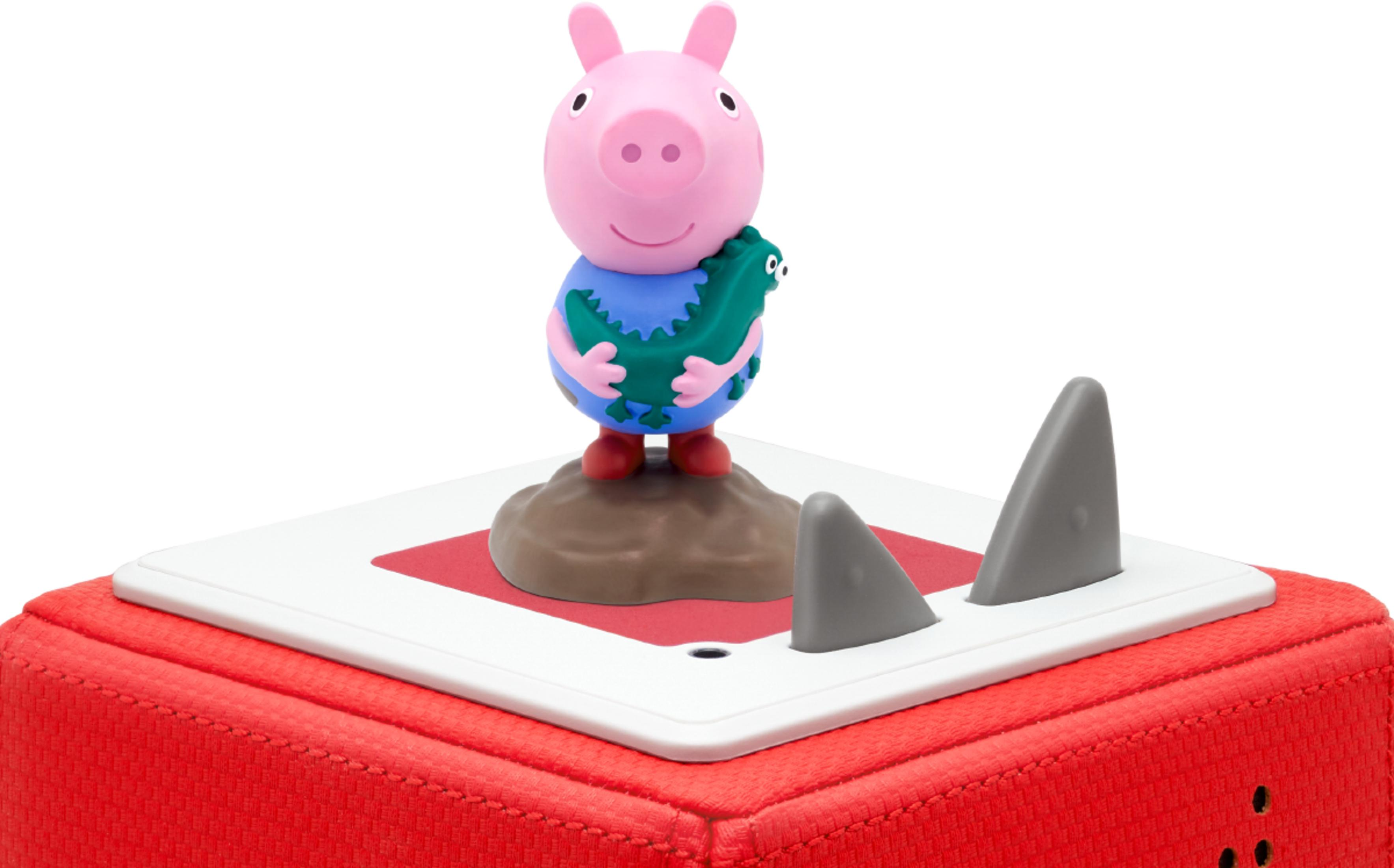 Peppa Wutz Figur auf einem roten Würfel mit Haifischflossen.