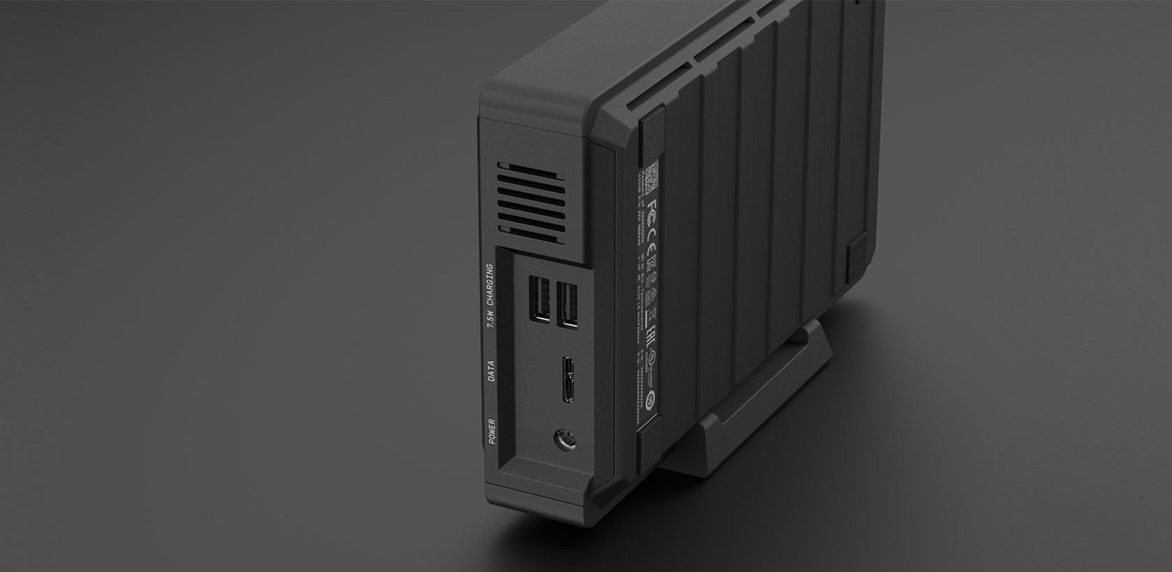 Czarna zewnętrzna obudowa dysku twardego z portami zasilania, danych, USB i ładowania 7,5W.