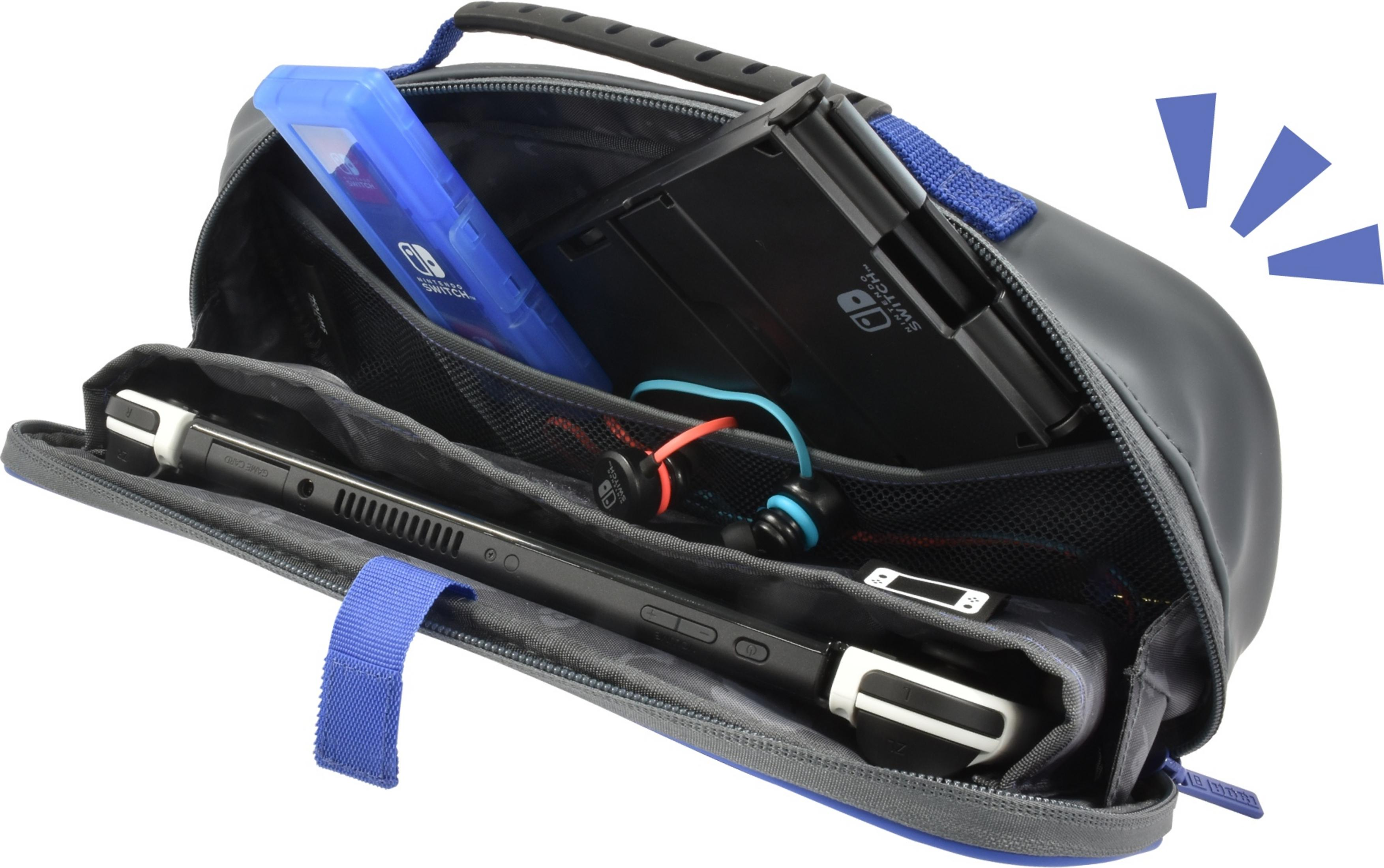 Szara torba z konsolą Nintendo Switch, etui, słuchawkami i uchwytem.