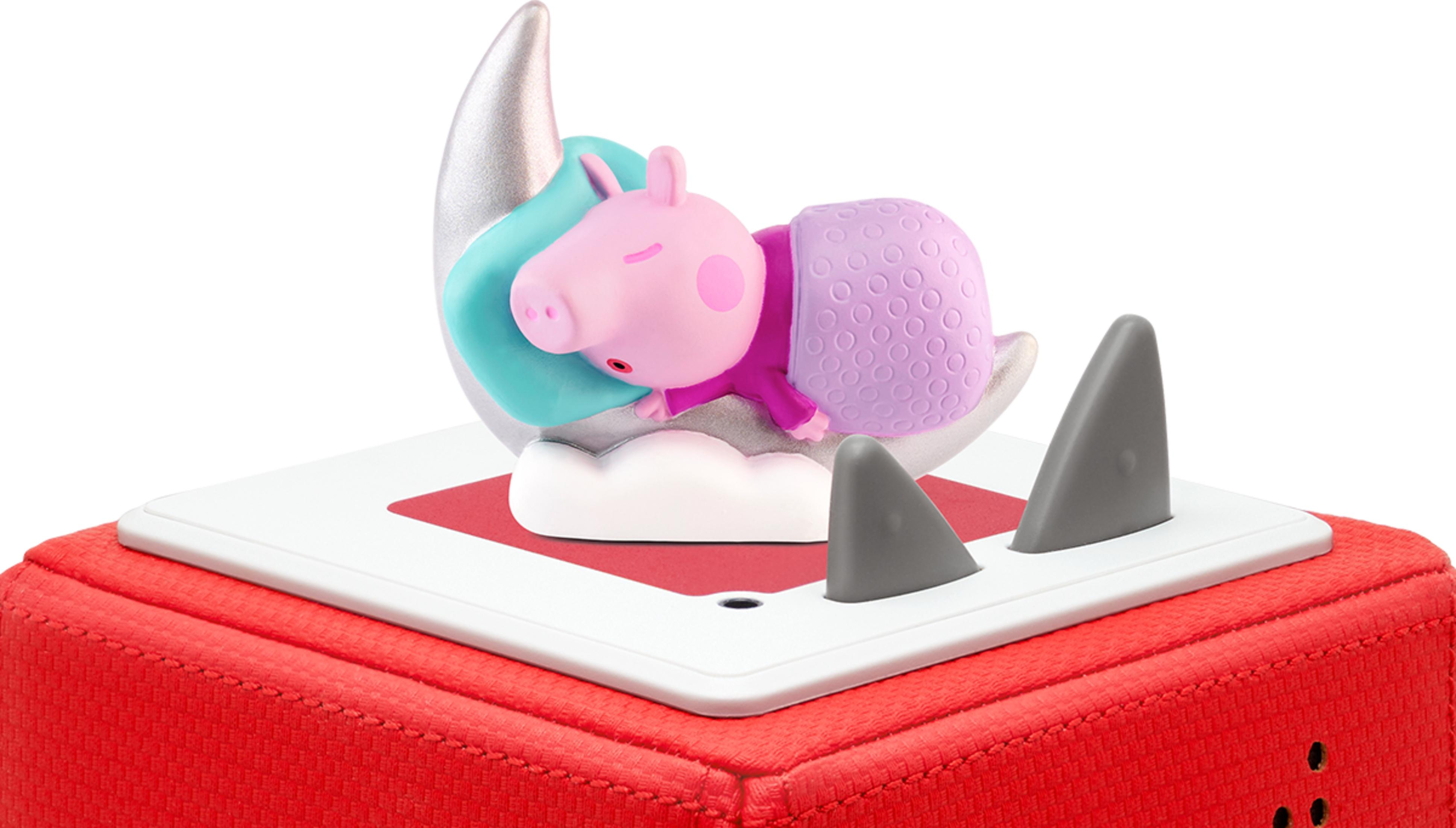 Peppa Wutz schläft auf einem Mond mit Hai-Flossen und einer roten Box.