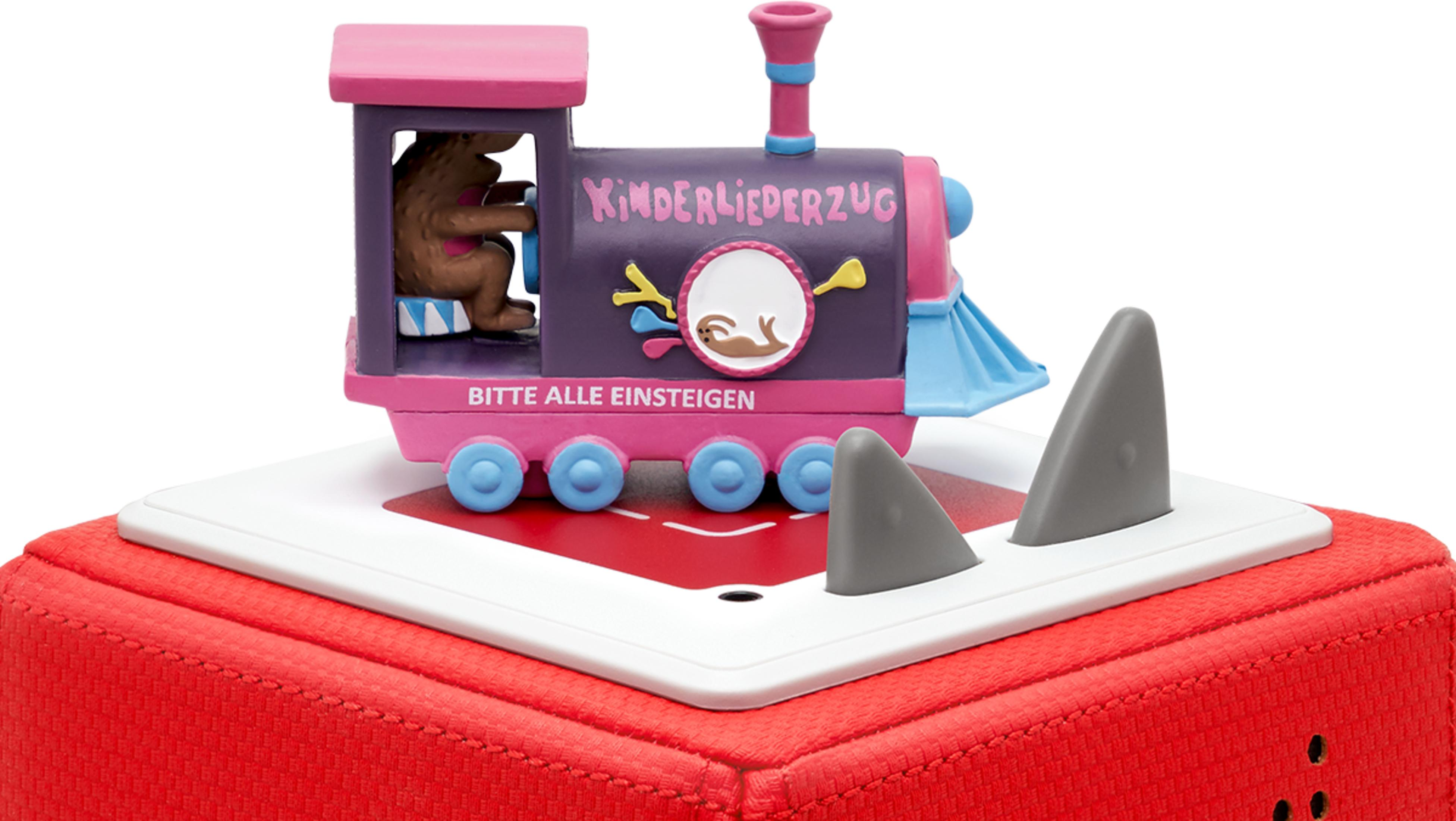 Ein lila Zugspielzeug mit einem Bärenfahrer auf einem roten Kasten.