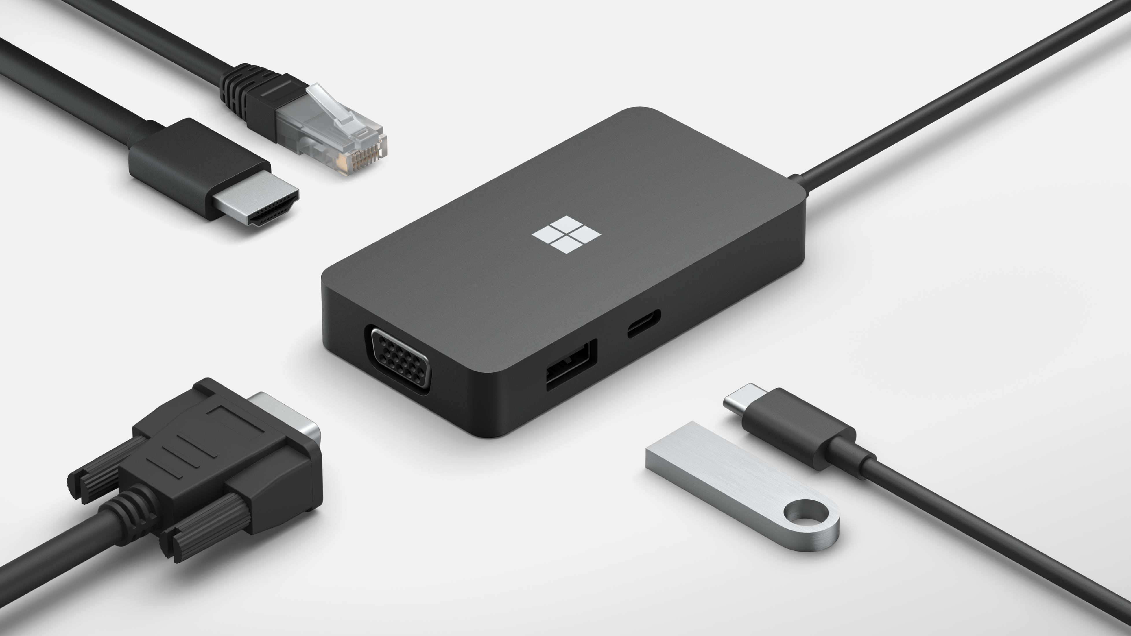 Ein schwarzer Microsoft-Adapter mit HDMI-, VGA-, Ethernet- und USB-C-Anschlüssen.
