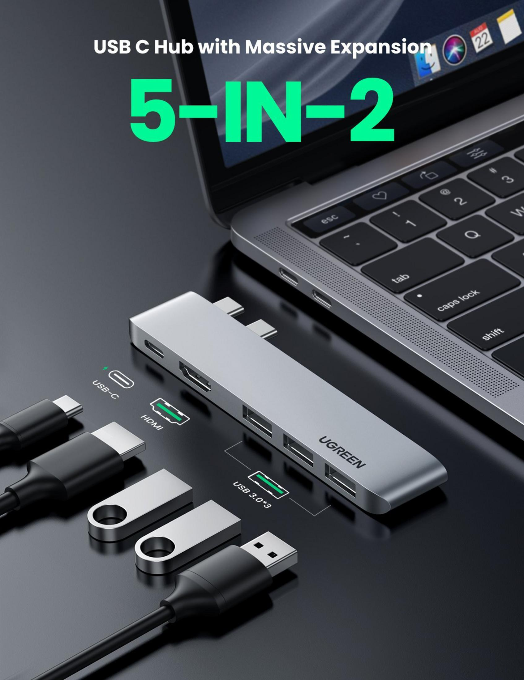 Srebrny hub USB-C z portami HDMI i USB 3.0, obok laptopa.