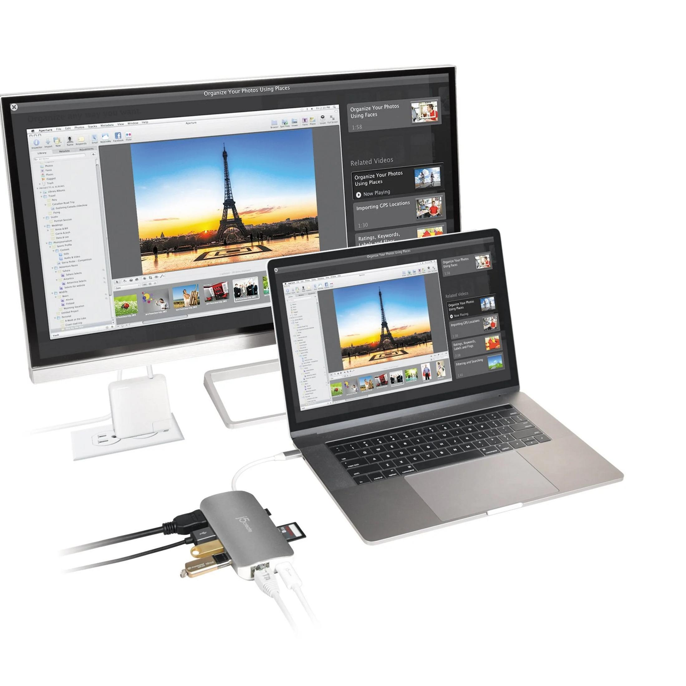 Ein Laptop und ein Monitor zeigen Bilder des Eiffelturms. Ein Hub verbindet beide.