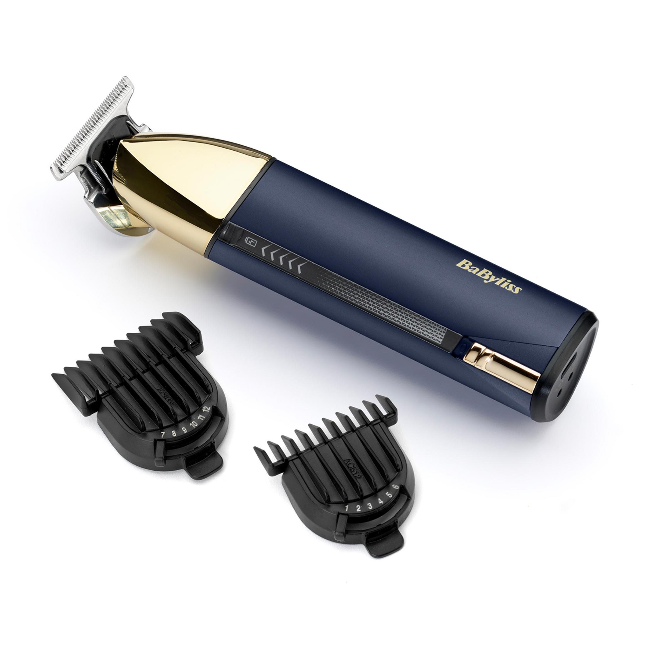 Dunkelblauer Haarschneider mit Golddetails und zwei Aufsätzen.