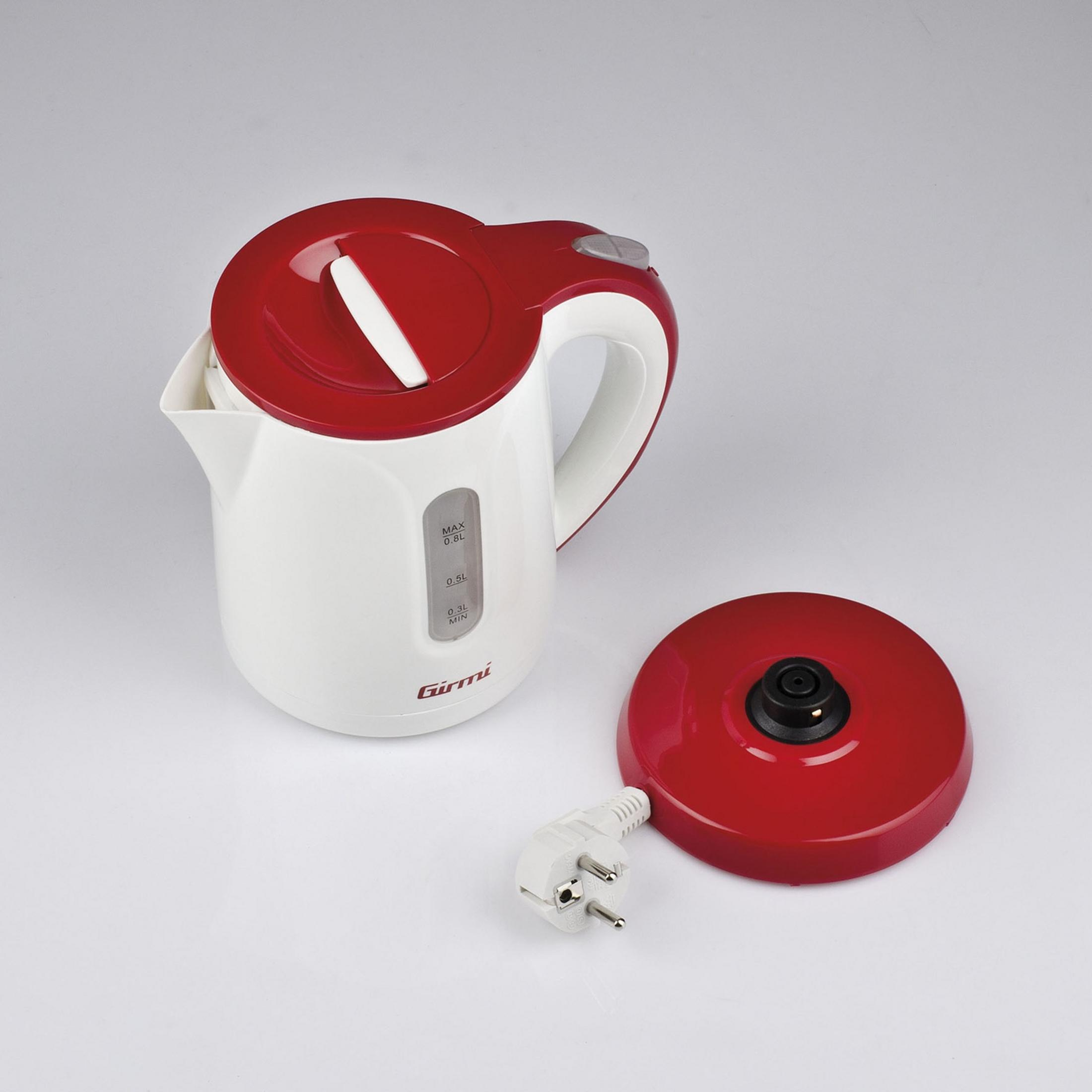 A white electric kettle with a red lid and base, with a plug beside it.