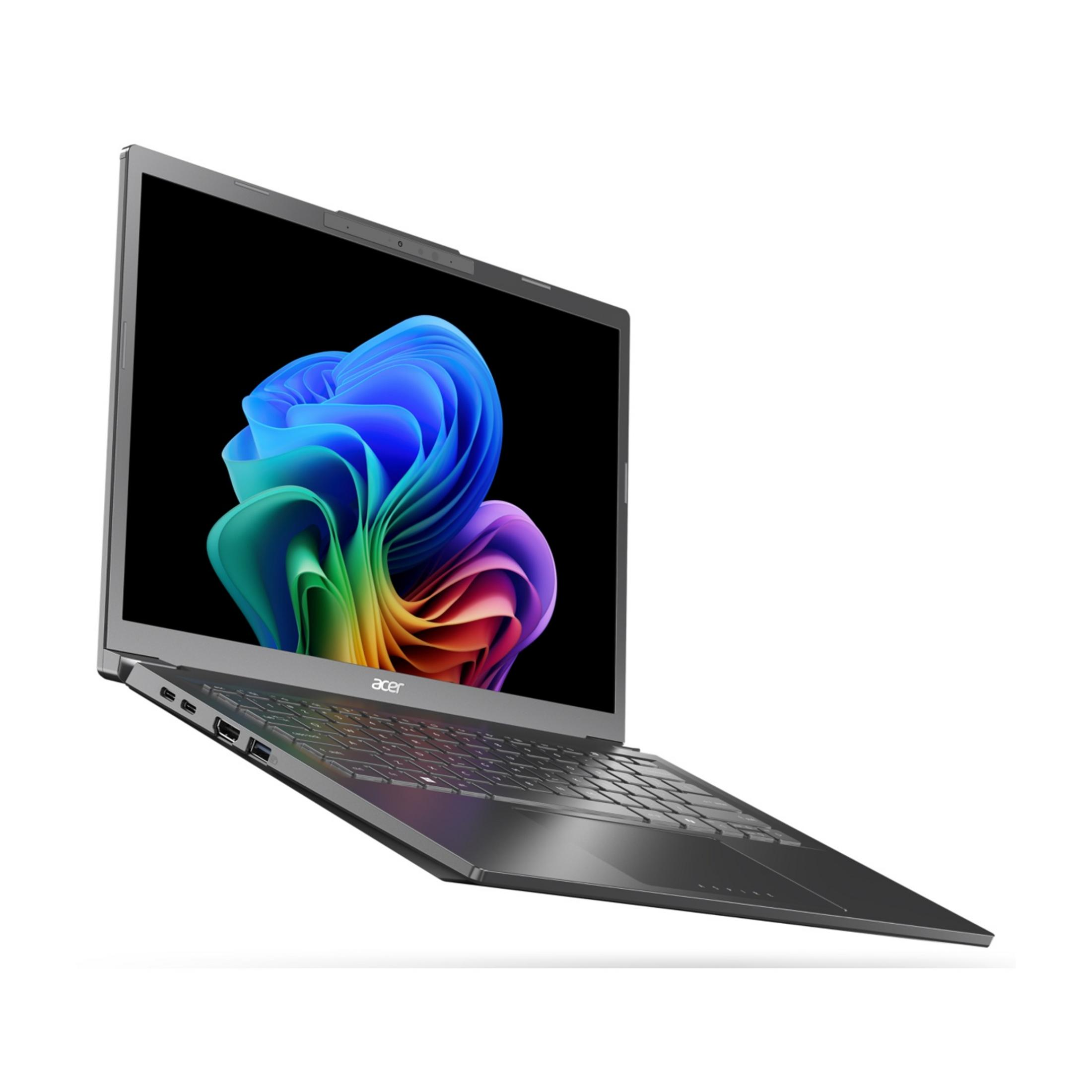 Un laptop grigio chiuso che mostra uno sfondo colorato.